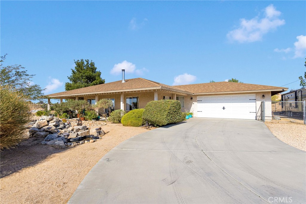 DRAMATIC 3 bedroom, 2 bath home on acreage with expansive views of the Victor Valley. This home features rural living with all the peace and privacy
you can imagine. The five acres provides plenty of room for gardening, outdoor activities or future expansion. Once inside, you’ll see a bright and open floor plan designed for comfort and functionality. The spacious living room, open to dining area and kitchen, showcases large windows that capture the enchanting desert valley and nighttime city lights. If you want natural light, this is the one. The kitchen offers ample cabinet space with beautiful quartz countertops and a large pantry. This area is perfect for entertaining family and friends. The primary bedroom features access to the patio along with an en-suite bath with dual sinks, separate tub and shower. The second bedroom offers its own door to a full guest bath. Outside you can let your imagination run wild, whether it be a hobby farm or giant garage/workshop. Or maybe you just want to relax and take advantage of the
spacious covered patio and take in the serene surroundings. Unwind in the jetted spa under the stars. Several mature trees and numerous shrubs are automatically sprinkled for easy maintenance. There is RV parking complete with a 30 amp hookup and sewer cleanout. This home is the perfect
blend of comfort and opportunity.