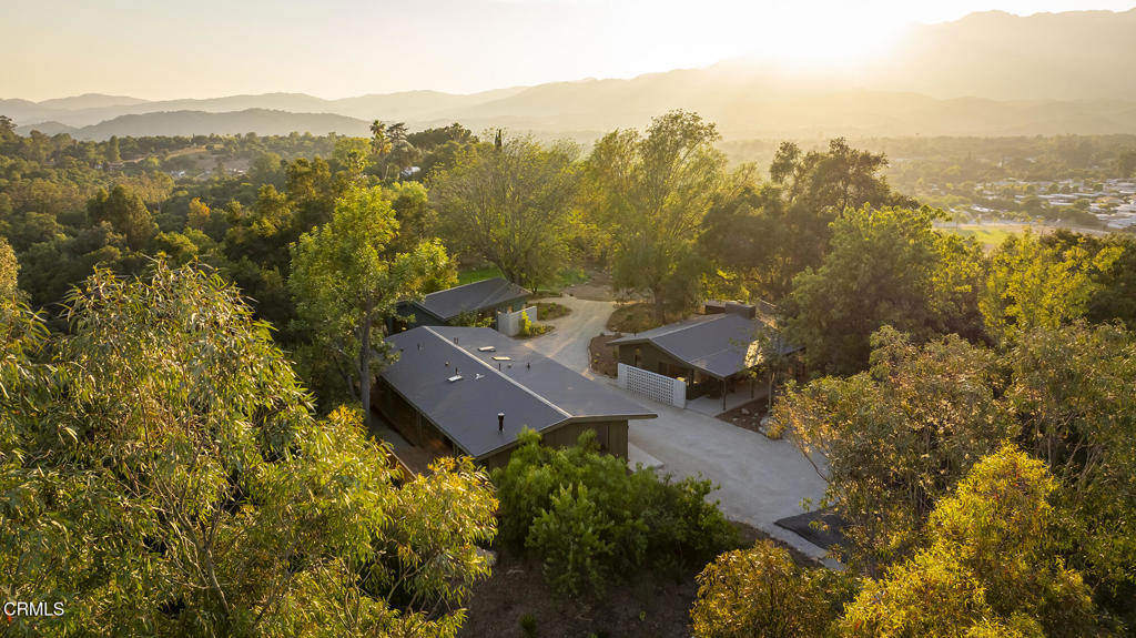 This extraordinary 2.5-acre estate is one of Ojai's most rare and refined offerings, located in a stunning ridge-top setting within the heart of the valley. Just minutes from downtown, the Ojai Valley Inn, and Villanova School, this private hilltop retreat offers panoramic 360-degree views, unmatched privacy, and a masterfully curated renovation that blends natural beauty with elevated living. Completed in 2025, every inch of the property has been meticulously renovated inside and out, combining timeless materials with modern craftsmanship. The main residence spans 1,450 square feet and is a stunning 3-bedroom, 2.5-bath. Thoughtful details are everywhere, from the solid oak floors and cedar-lined walls and ceilings, to handcrafted porcelain towel hooks, push-button light switches, and imported European tile at the entry. The chef's kitchen features honed Brazilian quartzite countertops, all-new appliances, and tilt-and-turn windows that open to a teak wraparound deck framing iconic views of the Topa Topa mountains. Bathrooms are finished with radiant heated floors, hand-selected tile work, and custom lighting. The home also includes brand-new HVAC, plumbing, electrical, and a fire-resistant metal roof. Just beyond the main house, the 623-square-foot guest house offers a studio-style layout with cedar interiors, polished concrete floors, a full kitchen, bath, and fireplace, ideal for guests, extended stays, or creative space. The third structure, a 599-square-foot finished two-car garage, continues the design language with polished concrete floors, cedar finishes, a half bath and outdoor shower, perfect as a gym, workspace, or overflow guest suite. The land itself is a sanctuary, dotted with mature trees, sculpted landscaping, and private walking paths that weave through the property. Perched high above the valley, the ridge-line setting catches a gentle, year-round breeze, creating a perfect microclimate. A private well services the entire 2.5 acres, supplying water for all landscaping needs, while a state-of-the-art water filtration system supports all three structures. This is more than a home, it's a private, architectural retreat designed for those who appreciate privacy, beauty, and an effortless connection to nature. A property like this comes along once in a generation, a true Ojai original.