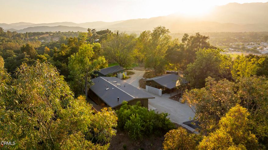 This extraordinary 2.5-acre estate is one of Ojai's most rare and refined offerings, located in a stunning ridge-top setting within the heart of the valley. Just minutes from downtown, the Ojai Valley Inn, and Villanova School, this private hilltop retreat offers panoramic 360-degree views, unmatched privacy, and a masterfully curated renovation that blends natural beauty with elevated living. Completed in 2025, every inch of the property has been meticulously renovated inside and out, combining timeless materials with modern craftsmanship. The main residence spans 1,450 square feet and is a stunning 3-bedroom, 2.5-bath. Thoughtful details are everywhere, from the solid oak floors and cedar-lined walls and ceilings, to handcrafted porcelain towel hooks, push-button light switches, and imported European tile at the entry. The chef's kitchen features honed Brazilian quartzite countertops, all-new appliances, and tilt-and-turn windows that open to a teak wraparound deck framing iconic views of the Topa Topa mountains. Bathrooms are finished with radiant heated floors, hand-selected tile work, and custom lighting. The home also includes brand-new HVAC, plumbing, electrical, and a fire-resistant metal roof. Just beyond the main house, the 623-square-foot guest house offers a studio-style layout with cedar interiors, polished concrete floors, a full kitchen, bath, and fireplace, ideal for guests, extended stays, or creative space. The third structure, a 599-square-foot finished two-car garage, continues the design language with polished concrete floors, cedar finishes, a half bath and outdoor shower, perfect as a gym, workspace, or overflow guest suite. The land itself is a sanctuary, dotted with mature trees, sculpted landscaping, and private walking paths that weave through the property. Perched high above the valley, the ridge-line setting catches a gentle, year-round breeze, creating a perfect microclimate. A private well services the entire 2.5 acres, supplying water for all landscaping needs, while a state-of-the-art water filtration system supports all three structures. This is more than a home, it's a private, architectural retreat designed for those who appreciate privacy, beauty, and an effortless connection to nature. A property like this comes along once in a generation, a true Ojai original.