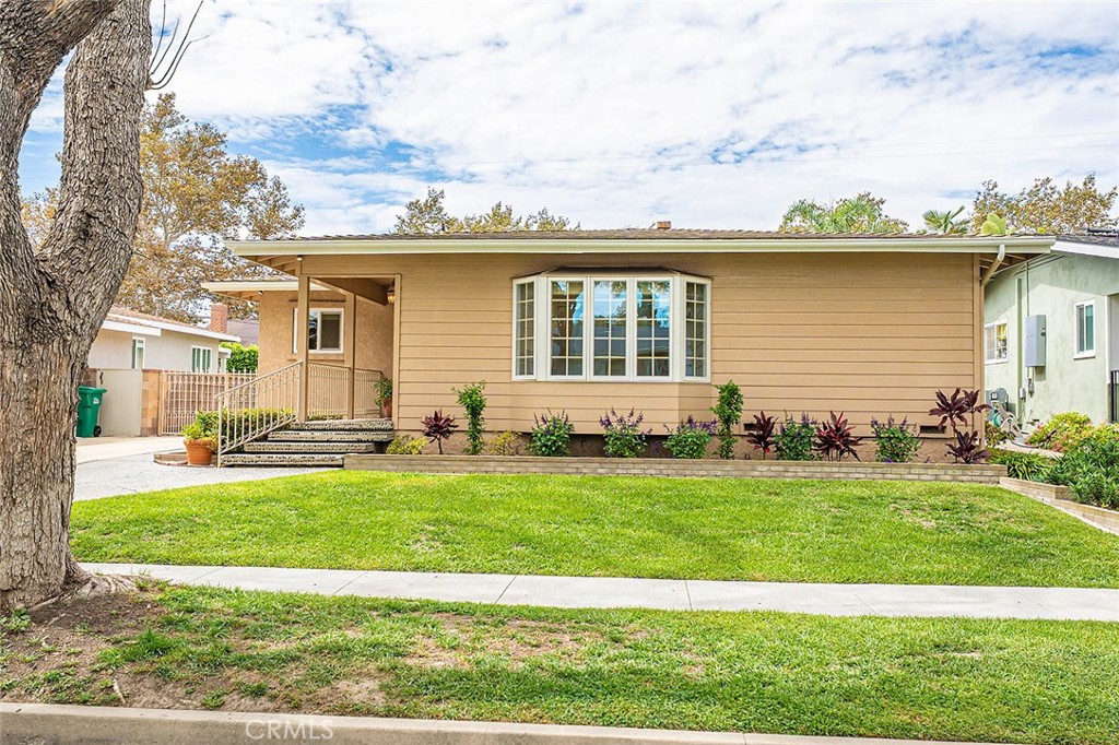 Nestled on one of the most picturesque, tree-lined streets in the highly sought-after Plaza neighborhood, this classic East Long Beach home is a true find. Owned and cherished by the same family for decades, it has been thoughtfully refreshed and is now ready for its next owner.
Step inside to discover newly refinished hardwood floors that gleam in the natural light, new carpet and baseboards, fresh interior paint, and recessed lighting. Important updates for peace of mind include a recently replaced main line (2023), copper plumbing, new water heater, and central heating and AC. Dual-pane windows and sliding doors throughout ensure year-round comfort and energy efficiency.
The bright, open floor plan flows seamlessly, offering a comfortable indoor-outdoor lifestyle. Sliding glass doors lead to a covered side deck - a special feature with slats strategically angled to let in maximum sunlight during winter and provide cool shade in summer. Imagine sipping your morning coffee here or hosting a barbecue with friends. The galley kitchen provides abundant counter space and storage, has a skylight for natural light, along with a breakfast nook and a view of the side deck. The expansive family room has plenty of room for relaxing, extra workspace with built-in storage, plus there’s a second fireplace and a wet bar.
The private backyard has a grassy area perfect for play, gardening, and relaxation, and the detached two-car garage is accessible via a long, private driveway. Located a couple of blocks from El Dorado Park, with easy access to multiple freeways and a variety of shopping options, including the vibrant Marina farmer's market, this home perfectly balances suburban tranquility with urban convenience. This is more than a house—it's a lifestyle waiting to be lived. Schedule your showing today!