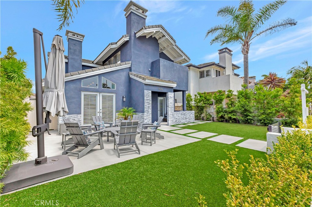 Nestled in a premium spot on sought-after Pine Street, this beautifully renovated home is located in Huntington Beach’s highly desirable Lake Park neighborhood—just moments from the beach, shopping, and dining. From the moment you arrive, the redesigned outdoor living space sets the stage for effortless entertaining and relaxed coastal living. Inside, the formal living room features soaring beam ceilings, abundant natural light, and a timeless fireplace that adds warmth and charm. The spacious dining area with a built-in wet bar flows seamlessly into the chef’s kitchen, complete with a large center island, JennAir stainless steel appliances, double ovens, and easy access to both the backyard and a private side patio—ideal for indoor-outdoor gatherings. A cozy den with a second fireplace offers a relaxed retreat, while a downstairs bedroom and full bath provide flexible living space perfect for guests or a home office. Upstairs, the expansive primary suite includes high ceilings, a private balcony, dual walk-in closets, and a spa-like bathroom with double vanities and a walk-in shower with dual shower heads. Three additional bedrooms—one with its own walk-in closet—share a spacious full bath with dual sinks. A second upstairs deck offers a quiet escape for evening sunsets or morning coffee. Additional highlights include an oversized laundry room, a finished three-car garage with built-in storage, and a 220V EV charger for modern convenience. Don’t miss your chance to own a truly special property in the heart of Lake Park.