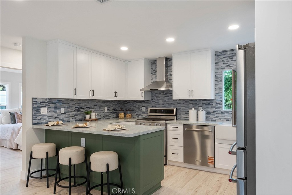 TWO NEW AND FULLY SEPARATE HOMES on one lot (one 4bed-3bath + a 2bed-2bath) for INVESTORS and/or FAMILIES in the sought-after Los Altos neighborhood—offering excellent rental income potential, multigenerational living, and future-ready infrastructure near Cal State Long Beach and top-rated schools. Located on one of the best streets in the area, this property includes a fully remodeled main home and a brand-new, ground-up ADU HOME with its own private address and entrance for added privacy and flexibility. Set in a safe, family-friendly community within walking distance to schools, parks, shopping, and CSULB, this is a prime opportunity for families or investors targeting student and professional renters alike. The main home has been expanded to 1,531 square feet and features 4 spacious bedrooms and 3 bathrooms. Nearly every major system is new, including sewer, gas, and water lines, updated electrical, insulation, drywall, and stucco, plus a paid-off solar system for long-term savings and energy efficiency. Additional upgrades include a new A/C system with all-new ductwork, a new water heater with recirculation line, and two laundry areas. The kitchen boasts brand-new stainless steel appliances—stove, microwave, fridge, and dishwasher. Interior improvements include new flooring, energy-efficient windows + doors, and custom closets in every bedroom. The finished garage has a new door and is EV-ready with a dedicated outlet. Outdoor enhancements include fresh sod, new sprinklers, drip irrigation, and a painted deck with anti-slip coating and new railing—ideal for entertaining, dining, or relaxing in a serene backyard setting. The main home can also be reconfigured into a 3 bed / 2 bath with a separate 1 bed / 1 bath JADU by simply closing a door, offering further versatility for rental or guest use. At the rear of the lot, a newly constructed 800 sq ft ADU includes a private entrance and address: 6300 E Fairbrook St, STE A, Long Beach, CA 90815. It offers two bedrooms and two bathrooms, including a primary suite with a built-out closet, a full kitchen with new appliances, in-unit laundry, and stylish modern finishes throughout. It’s perfect for rental income, guests, or extended family. This rare two-home offering blends quality construction, thoughtful design, move-in ready convenience—perfect for investors, multigenerational households, or anyone looking to maximize lifestyle and long-term value in one of Long Beach’s most desirable neighborhoods.