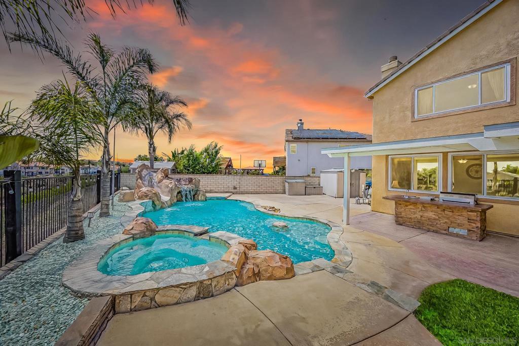 Pristine Ocean Hills Gem – Entertainer’s Dream! Welcome to this beautifully maintained five-bedroom home nestled in the highly sought-after community of Ocean Hills. Set in a pristine location, this mint-condition residence offers the perfect blend of elegance, comfort, and indoor-outdoor living. Enjoy unforgettable gatherings in the expansive pie-shaped backyard, thoughtfully designed for entertaining with a spacious patio, built-in barbecue area, and lush surroundings. This home truly is an entertainer’s delight, inside and out. Whether you’re hosting or relaxing, the seamless flow and immaculate condition make this property a rare find. Immaculate home in pristine condition with extensive upgrades throughout. Features include new Elor Diamond Level energy-efficient windows, SunPower solar panels, and Flex-On exterior paint with a lifetime warranty. Enjoy added security with a 4-camera surveillance system. Interior highlights include a new Samsung dishwasher, a high-end stove with dual ovens and built-in air fryer, and upgraded blinds. The garage is equipped with two 220V outlets—perfect for EV charging or workshop use. The backyard is an entertainer’s dream with a newly installed metal fence, built-in Bull BBQ grill, and a custom-designed rock pool featuring a slide, two waterfalls, a cave, and a built-in table top for drinks. Situated on an extra-large lot with stunning canyon views and ample space for relaxation or entertainment. This home is move-in ready and offers exceptional value and quality throughout.