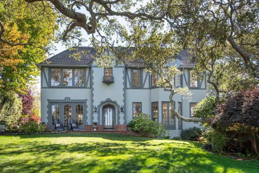 A gated herringbone brick entry and manicured garden present a picture-perfect introduction to this private setting. Inside, deep crown molding and mahogany hardwood flooring appoint light-filled, generously sized rooms. An expansive living room with fireplace flows across the entry foyer to the formal dining room. The charming breakfast nook opens one of several patios. Featuring brilliant natural light, the chefs kitchen blends beauty and functionality. Nearby, the family room with its built-in media cabinetry and hand-hewn cross beam ceiling, opens to the resort-style rear patio and grounds.  A powder room and full bedroom suite complete this level. The distinctive staircase leads one upstairs to the grand primary suite with fireplace, spacious bath & dual walk-in closets. 3 additional bedrooms and 2 marble baths surround a central hallway. Amenities include Lutron lighting, lush and well lit landscaping, sunny pool, hot tub and fully equipped outdoor kitchen. Your private oasis!