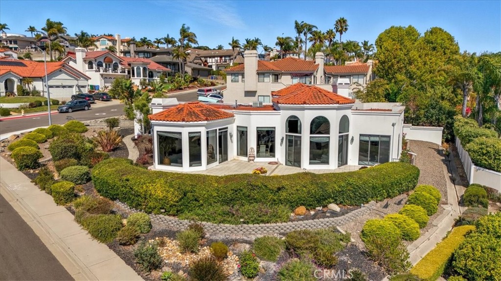 Elegant, single level, hillside home in Pismo Beach with sweeping ocean views. This three bedroom, three bath Central Coast home is open, inviting, and filled with natural light. The grand entry has beautiful marble floors, a dazzling chandelier, and flows into the living room with stunning, distant blue water views. The gorgeous cathedral ceilings, paneled in a light-colored wood with open beams, give the home a spacious feel. This property is perfect for entertaining with its expansive view patio, wet bar, and chef’s kitchen with induction cooktop, center island, and breakfast bar. The kitchen opens to the generous family room which has built in bookshelves and fireplace. The primary suite has its own fireplace, large walk-in closet, and spa-like primary bath. The home offers many built-ins and ample storage closets and cabinets. The over-sized three-car garage provides plenty of space for a workshop or art studio with direct access to the kitchen. Enjoy all the Central Coast has to offer including proximity to the beach and to both San Luis Obispo and Arroyo Grande. Information not verified.