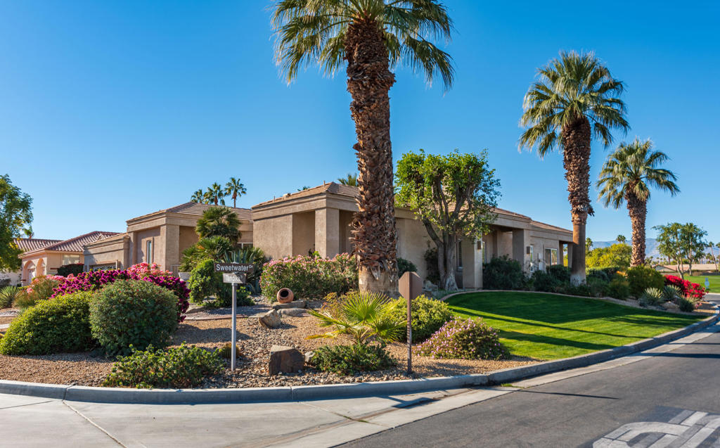 STUNNING UNIQUE PROPERTY!Situated on an elevated corner lot is this fabulous custom home on the private Avondale Golf Course with panoramic views of the western mountains and unbelievable gorgeous sunsets. The home is 3 Bedrooms, 3 Bathsplus a powder room and office, at 3,355 square feet, on an extra large lot of 13,504 square feet.As you enter the living room, you will find exquisite lighting , high ceilings and various lighted niches showcasing beautiful Southwest Art. The Kitchen features stainless appliances, white cabinetry, corian countertops and walk-in pantry. The bright open kitchen is designed forfunctionality, style and has a cozy casual dining area. The Master bedroom is quite spacious with an attached office and wonderful walk in closet. The ensuite bathroom features a Jacuzzi tub,oversize shower with seat and sauna. There aretwo ensuite guest bedrooms - one being used asa den with built-in King size Murphy bed. The Laundry room features washer & dryer withseparate utility tub with an abundance of cabinetry. The home is light and bright with large ceramic tiles throughout and carpeted bedrooms. There is a 3-car garage, with one being a golf cart garage, featuring many storage cabinets and beautifully finished epoxy flooring. The landscaping around the home boasts majestic palm trees with a bit of desertscape. There is a fabulous Pebble Tech lap pool with spa & waterfalls. Doggie park nearby - just down the street. Home is being sold turnkey furnished, including artwork & sculptures.