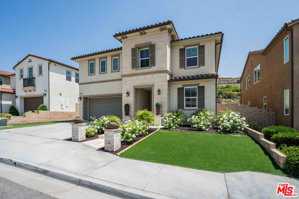 *No Mello-Roos = Potentially $500+/mo savings* Discover modern elegance at 19173 Lauren Ln, Santa Clarita, CA 91350. Originally built by luxury home builder, Toll Brothers in 2018, this stunning 5-bedroom, 3-bathroom home boasts custom exterior features, including a travertine entrance, ledger stone posts, and high-end artificial turf. Inside, enjoy tile and hardwood flooring throughout the entire home, designer craftsman trim, and updated fixtures. The backyard oasis features a matching outdoor kitchen and pergola with recessed lighting, and a limestone-covered planter. Perfect for luxurious living and entertaining.