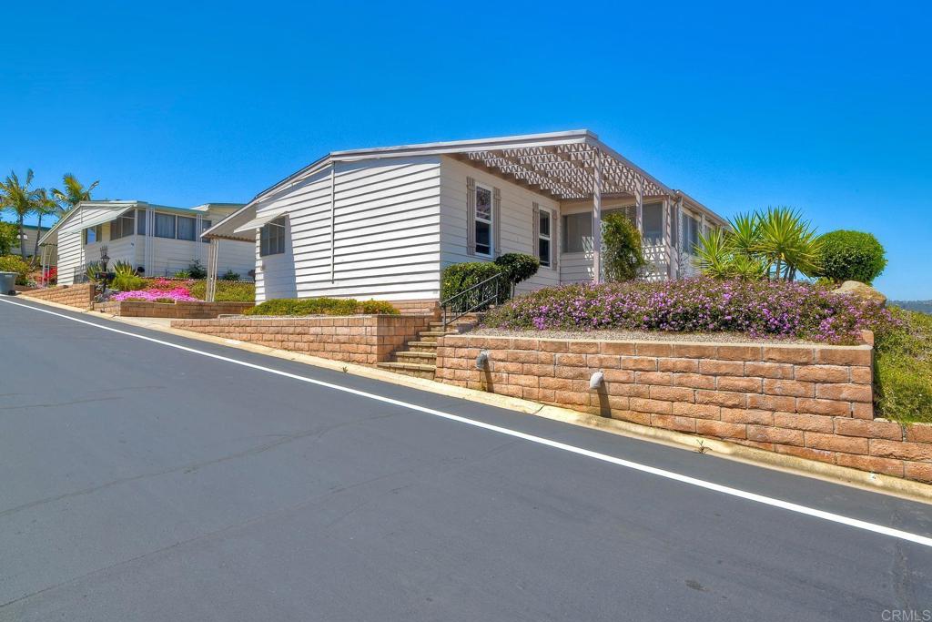 Nestled high on the hill in La Moree Estates, this home has great views of the mountains in the distance. Light and bright inside, the layout is spacious with a bonus attached room with lots of windows, offering a nice breeze. New carpet and a roof that is 3 years young. La Moree Estates is a 55t community where residents own the land. The HOA fee includes a community pool, clubhouse and RV parking (if available), water, trash, sewer, and cable. Conveniently located to shopping, Palomar and Kaiser hospitals.