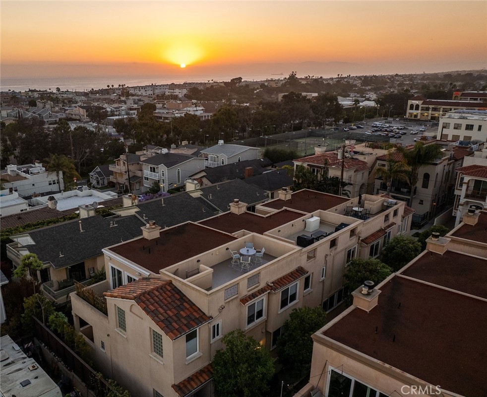 Welcome to this gorgeous OCEAN VIEW 3 bedroom, 2 ½ bathroom townhome with 3 outdoor decks located in the heart of Hermosa Beach. The upstairs living area features a spacious open floor plan with ocean views, cozy fireplace, hard wood flooring, a spacious living room, dining area. kitchen and guest bathroom. The kitchen has granite counter tops, stainless steel appliances, double ovens, cook top and peninsula with countertop seating. Enjoy the ocean breezes from the living room that leads to one of the ocean view decks perfect for entertaining and outdoor dining. From this level a staircase leads to a private rooftop deck with stunning panoramic views. On the entry level you will find 2 spacious bedrooms with ample closet space and the primary bedroom. The primary bedroom has two walk-in closets, private balcony, fireplace and a large ensuite bathroom with a double vanity. All the bedrooms feature hardwood flooring. The lower level offers flexibility with an additional room for a home office, gym, or playroom. On this level you will find a laundry room and storage closet and direct access to the oversized 2 car garage with plenty of room for additional storage. This back unit townhome offers an additional off-street driveway parking spot . Conveniently located and just a short distance to the greenbelt, South Park, Hermosa Valley School, shopping, coffee shops, grocery stores, numerous downtown restaurants, the beach and bike path.