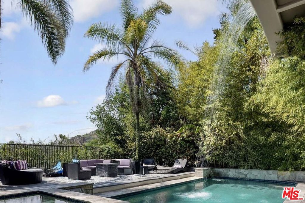An ultra-private compound of 7,000 sq. ft., offering sweeping skyline views from multiple balconies and terraces. Behind a gated motor court with generous parking and a 3-car garage plus 3 additional spaces inside the gate, the estate includes 6 en suite bedrooms and 10 bathrooms, highlighted by a grand primary suite with sitting area, private balcony, fireplace, large walk-in closet, and spa-inspired bath with soaking tub. Living and entertaining spaces feature a sunken living room, formal dining, family room, and spacious kitchen, while the mid-level adds a media room, full bar, and second kitchen.Outdoor living is defined by a saltwater pool and spa, cascading waterfall, and fully equipped kitchen and bar. A private wellness center with gym, sauna, and steam shower completes the retreat, supported by a robust security system. The sixth en suite bedroom features a private entrance. Additional entertainment areas include a media den, wine room, full bar, and separate kitchen. A private elevator provides seamless access across the main three levels of the estate, while a separate-entry suite occupies the fourth level for added privacy.Offered individually at $4,750,000, or as part of a bulk portfolio with 8827 and 8835 Evanview for $14,000,000 a rare opportunity to acquire multiple turnkey estates in the Hollywood Hills. Perfect as a private compound or as a strategic luxury rental investment, including 1031 exchanges or the option to live in one residence while generating income from the others. An irreplaceable opportunity in the Hollywood Hills.