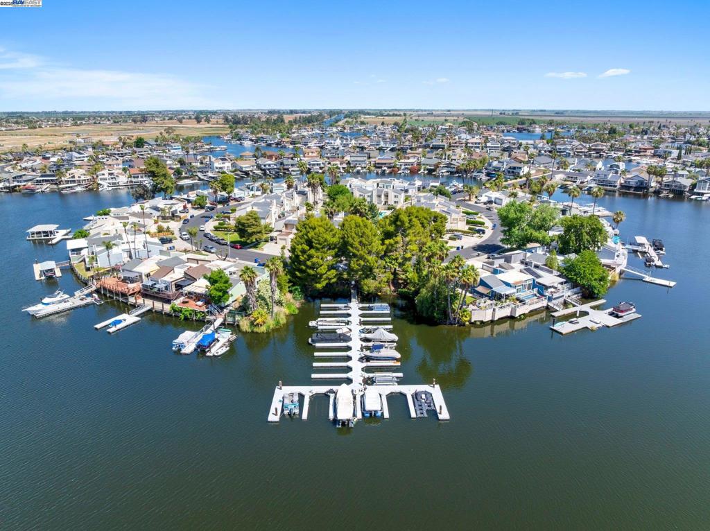 This beautiful townhome is located in close proximity to "Fast Water" with a gated community dock. The main floor entry has a refinished deck and upgraded glass door along with a custom slider. The luxury wood-like floors run throughout the home. The updated kitchen has stainless steel appliances and upgraded cabinets with pull-out drawers. The half bath is accented with custom features, including extra storage. Upstairs are the home's large primary suite as well as two bedrooms with their own deck. The primary bath is updated along with an excellent walk-in closet. The updated hall bath also has quartz counters. New windows and sliders are installed throughout. The rooftop deck is newer and ideal for entertaining. The home also has it's own private access to the community pool and clubhouse. All in all offering a perfect retreat into Discovery Bay Living! https://clout-real-estate-marketing.aryeo.com/sites/gemzoba/unbranded