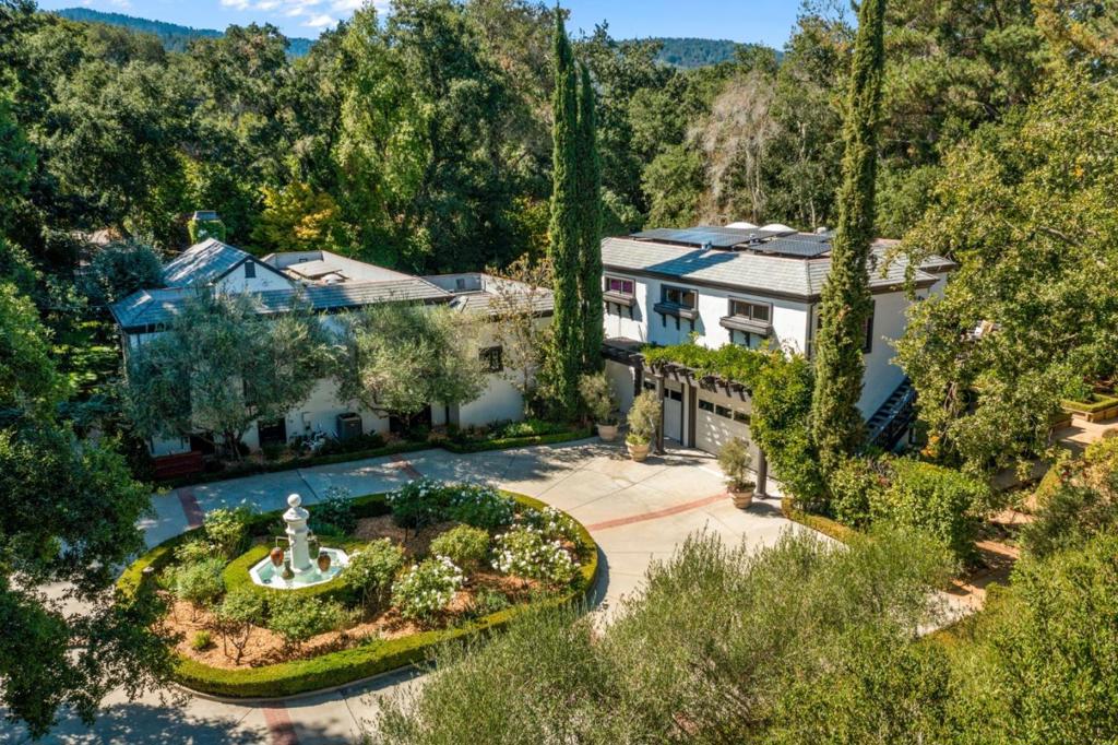 Location, location! This lush jewel estate is located along central Woodside's most exclusive Mountain Home Road corridor. A rarely available opportunity to own a 1.25 flat acre property in the heart of the town's most prestigious neighborhood, discover an effortless blend of fine craftsmanship with luxurious elements and a touch of Hollywood style: 4(+1) brs, 4.5 ba plus an array of multi-functional spaces: a main-level suite easily converts to lounge/5th bedroom, the primary suite is enhanced by a private library/office/ walk-in closet, nursery or 2nd bedroom. Venture to the wine cellar with its own tasting room through a potential home theatre. An entertainer's dream for elegant al fresco afternoons by the pool and easy indoor/outdoor living, and the expansive grassed yard is framed for utmost privacy by pristine mature landscaping, a romantic rose garden, olive and fruit orchards. A short walk to town and the Woodside Elementary School, this garden estate balances peaceful seclusion with close proximity to all commuter routes and less than 20 minute drive to SFO Airport.