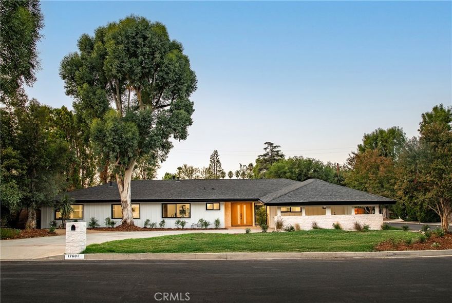 Welcome to this stunning single-level estate, tucked away on a private corner lot in Encino’s coveted Amestoy Estates. Recently and thoughtfully renovated, this home blends modern luxury with everyday comfort, offering an exceptional lifestyle in one of the Valley’s most sought-after neighborhoods. Step inside to an abundance of natural light and an open layout that immediately sets the tone. Expansive windows and bifold doors seamlessly connect the interiors to the outdoors, showcasing beautifully landscaped grounds, a resort-style pool, and inviting entertaining spaces—all while filling the home with warmth and light. The open-concept design effortlessly links the chef’s kitchen, living room, family room, and dining area, creating a functional flow that is ideal for gatherings and adapts seamlessly to both lively celebrations and quiet evenings. The spacious primary suite serves as a private retreat, with large sliders framing serene backyard views, a spa-inspired en-suite with dual vanities and a walk-in shower, and immense closet space. Four additional bedrooms provide flexibility for family, guests, or a home office. The backyard is a true California paradise, with a PebbleTec pool featuring cascading water features, multiple lounge and dining areas, a built-in BBQ, and a lush green lawn, creating an outdoor sanctuary designed for both unforgettable entertaining and everyday relaxation. Equally impressive, the front yard offers striking curb appeal with meticulously landscaped grounds and an expansive driveway that blends elegance, functionality, and a grand sense of arrival. All of this sits on over a quarter-acre flat lot, just minutes from the vibrant energy of Ventura Boulevard with premier dining, shopping, and entertainment. Here, style, comfort, and location come together—this is California living at its finest.