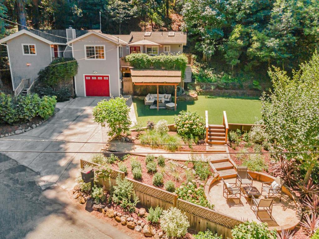 Felton's Favorite-Fall Creek! This mountain gem has fresh interior paint & beautiful landscaping. The open concept-living room flows into the dining area & kitchen. High ceilings & multiple skylights provide natural light & views of the majestic Redwoods. The kitchen has granite counters & stainless appliances and an abundance of cabinets. The wood stove will keep you warm and cozy on those cool mountain evenings. The primary ensuite has a ceiling fan and a walk in closet with built in organizers. Two more bedrooms also have closets with built-in organizers-one with a rustic barn door! The private upper deck is your great escape-enjoy soaking in your hot tub and grilling with loved ones. Downstairs is another room used as an office or guest room. Enter the garage at the bottom of the stairs where you will find a laundry area and a workshop space with builtin cabinets. A fragrant lilac archway leads you into the newly landscaped lower yard with a fire pit area and apple tree. The upper yard has newly installed turf for easy/low cost maintenance. Hike in Fall Creek State Park at the end of the road! Walk to schools, Downtown Felton, Emerald Mallard & Humble Sea, Felton Music Hall & Farmers Market. Easy drive to Santa Cruz Beaches/Los Gatos/Bay Area. Fall in love with Fall Creek!