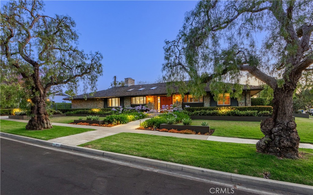 Located in the heart of Long Beach's sought after Park Estates neighborhood, 1251 Bryant Road is a sprawling single-level mid-century modern ranch style home sited on a large 10,375 SF lot. Designed by architect Raymond A. Sites— this home, which he referred to as Villa Verde, is a testament to his visionary approach to architecture. Positioned on a prime, interior corner lot, the custom residence boasts exceptional curb appeal with a beautifully landscaped front yard. The residence features 3 bedrooms plus a home office, 3 bathrooms, and 3,072 sq. ft. of living space. The home’s striking Palo Verde stone façade, mahogany doors and accents, and oak flooring provide a warm, timeless appeal. The expansive 30-foot great room with vaulted, beamed ceilings and generous use of windows and sliders is at the center of the home. Gourmet kitchen is equipped with high-end appliances, an extra-large island, casual eat-in dining area, workstation, and is open to the family/great room. Separate den with stand behind bar adds a delightful sophistication. The primary en suite offers a private retreat, complete with a cozy fireplace, updated bathroom, and two walk- in closets. The additional two bedrooms are spacious with upgraded hall bathroom. There is a wonderful indoor laundry room and separate mud room. The Napa inspired backyard is equally impressive featuring a beautiful slate patio with thoughtful lighting, stone planters, and an outdoor kitchen with grill and smoker—perfect for al fresco dining. Covered patio/loggia space, fireplace, spa, and water wall feature providing an organic and peaceful and relaxing feel. The large lot offers tons of space for enjoying the outdoors with grassy areas and mature trees that add privacy and beauty. There is an elegant gated driveway and attached garage. Living in Park Estates the residents enjoy the beautiful tree-lined streets, wide lots, and tight-knit community. Minutes from Alamitos Bay, this residence is ideally situated to enjoy the best of both worlds: neighborhood living with convenient access to the nearby beaches. Top-rated schools, local amenities, numerous golf courses, and local parks. Nearby Alamitos Bay offers watersports, kids camps, SUP, boating and sailing. Nearby Seal Beach with its charming Main Street and scenic pier. Centrally located to LA, the South Bay, and Orange County. 1251 Bryant Road is a rare opportunity to own a piece of architectural history in one of the area's most sought-after communities.