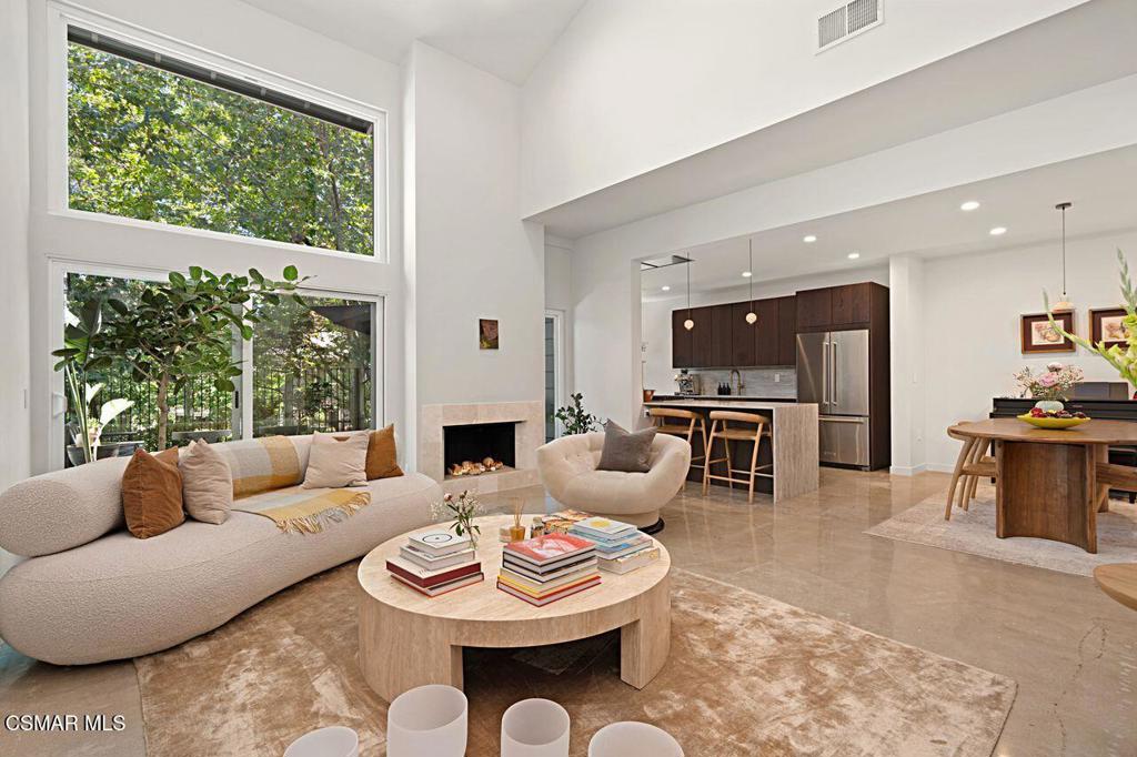 This stunning 3-bedroom, 2.5-bath contemporary townhome has been completely reimagined and rebuilt from the ground up with exceptional attention to detail. Walls were thoughtfully removed to create a flowing, open-concept layout inspired by Wabi-Sabi aesthetics--where simplicity meets serenity.Tucked within the sought-after Club View community, right next to the North Ranch Country Club, this home offers an unparalleled combination of style and location. Over $400,000 in meticulous renovations were completed in April 2024--this is not a flip, but a labor of love.Every inch has been upgraded with luxury and functionality in mind: brand-new recessed lighting, stainless steel appliances, designer toilets, Emtek hardware, custom solid wood interior doors, premium vinyl plank flooring, ELFA custom closets, and a breathtaking marble fireplace. The spa-like primary bath features a deep soaking tub and high-end Kohler fixtures for a truly Zen-inspired retreat.Step outside onto a tranquil back patio deck, where mature oak trees frame picturesque views of the North Ranch Country Club golf course, offering peace, privacy, and natural beauty in every direction.This turnkey home is ideal for the discerning buyer seeking effortless luxury, timeless finishes, and move-in-ready convenience in one of North Ranch's most coveted enclaves. Homes of this caliber are rare--don't miss the opportunity to make it yours.