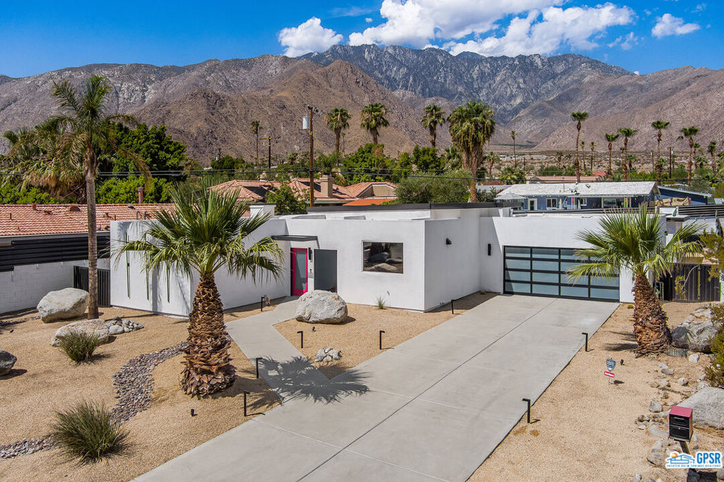 Contemporary and stylishly updated 3-bedroom, 3-bathroom home in the Chino Canyon neighborhood of Palm Springs. The main house features an open-concept kitchen with a generous bar area, sleek concrete floors, and a spacious living room with a gas fireplace, ideal for comfortable everyday living and entertaining. Two primary suites include walk-in showers and sliding doors that open directly to the outdoor space. A detached guest house offers a private third bedroom and bathroom, perfect for visitors, extended stays, or a dedicated home office. Step outside to take in stunning mountain views from the pool and spa, or unwind by the built-in fire feature under the desert sky. Additional amenities include a two-car garage, in-home laundry, and utilities included: solar electricity, water, trash, landscaping, and pool service.