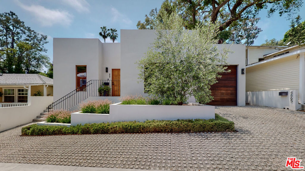 Perched on a quiet cul-de-sac in the hills of Eagle Rock, this newly developed Mediterranean-inspired home embodies the essence of refined Southern California living. Thoughtfully designed with architectural precision and built to the highest standards, the residence offers a harmonious blend of light, space, and texture that feels both luxurious and welcoming. Upon entering, you are greeted by an expansive open-concept floor plan that immediately captures the eye with its soaring 12-foot ceilings, walls of glass, and an effortless indoor-outdoor transition. The great room flows seamlessly into a gourmet chef's kitchen that serves as the heart of the home. Outfitted with a striking La Cornue range, bespoke white oak cabinetry, honed limestone countertops, and a dramatic waterfall-edge island, this kitchen is as functional as it is breathtaking equally suited for intimate family dinners or large-scale entertaining. The adjoining dining and living spaces open to multiple outdoor areas, where verdant landscaping, gentle breezes, and serene hillside views set the stage for relaxed al fresco gatherings. Morning coffee on the patio, weekend barbecues, or sunset cocktails, every moment here feels like an escape. The residence includes three generous bedrooms and three meticulously designed bathrooms. The primary suite is a private retreat reminiscent of a boutique hotel, complete with a spacious walk-in closet, a tranquil spa-like bathroom featuring custom tile work, a large glass-enclosed shower, and direct access to two separate patios. Each finish and fixture throughout the home has been hand-selected to convey understated elegance and natural beauty, from the soft oak tones and stone surfaces to the sleek matte hardware. This impeccable property offers versatility, privacy, and timeless appeal. This property is a sanctuary, away from the bustle of the city, and delivers a rare balance of elegance and functionality.Perfectly situated in a central NELA location, you are moments away from the acclaimed dining, shopping, and culture of Colorado Boulevard, while still enjoying the tranquility of hillside living. This is Eagle Rock at its most sophisticated home where every detail invites comfort, beauty, and connection.
