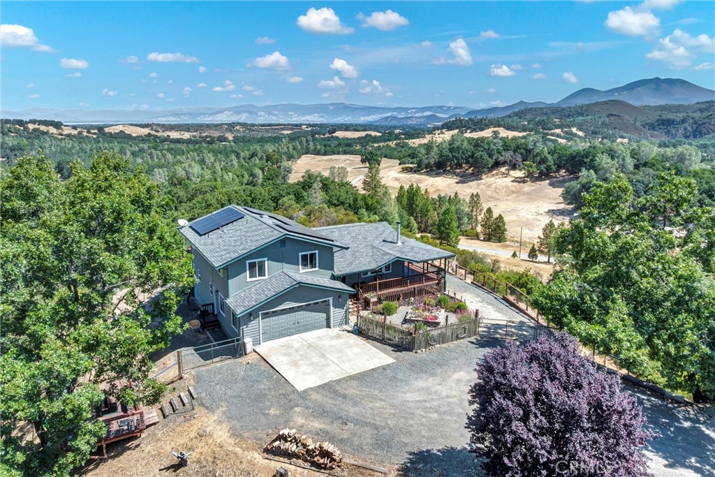 WHAT A VIEW RANCH on Hummingbird Hill. This 29-acre property will fill your soul with the wonder and the serenity of private country living. This 3-bedroom, 3-full bath home is just the right size and includes a private downstairs studio with fully equipped kitchen, full bath, and covered deck. All kitchens and baths have been tastefully remodeled. The open living area and all bedrooms are surrounded by the views of stunning sunrises, sunsets, hills, Mt Konocti and Clear Lake. If you like to cook, the well-designed kitchen has beautiful Ubatuba granite counters, lots of cabinets and room for those extra appliances we love that add to the joy of cooking. Enjoy anytime of day relaxing on the covered decks that wrap around the home. For anyone that wants their own shop, check out the carriage house when you schedule your viewing. There is lots of space for cars, shop benches and shelves as well as two extra unfinished rooms for office and hobby. Make this property your next adventure for country living for you. Home Warranty included.