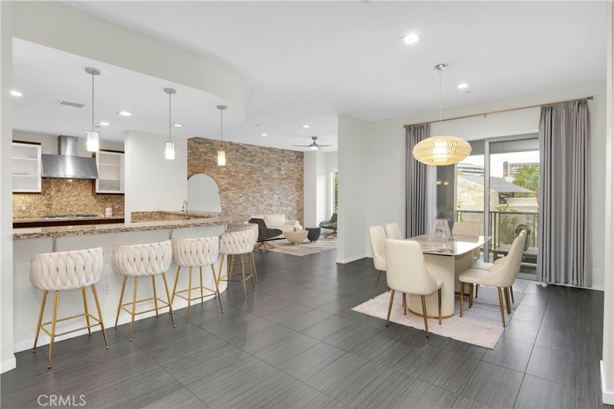 Welcome to the largest available residence at The Belvedere in Central Park West, where modern luxury meets urban convenience in the heart of Irvine’s Financial District. This highly upgraded, single-level 2-bedroom, 2.5-bath flat is ideally situated on a premium second-floor location with panoramic views and just steps from the clubhouse.This sophisticated home features an open-concept floor plan, soaring 10-foot ceilings, and abundant natural light. The chef’s kitchen boasts European cabinetry, a large center island, and ample counter space—perfect for cooking and entertaining. The expansive living area opens to a private balcony ideal for enjoying sunset and city views.The primary suite offers a luxurious retreat with a spa-inspired bath, custom glass tile finishes, and a spacious walk-in closet. Thoughtful upgrades throughout include beautiful porcelain tile flooring, slate accent walls, designer ceiling fans, custom carpet in bedrooms, LED lighting, and elegant glass tile accents in bathrooms.Additional features include a private deck, two gated subterranean parking spaces, and private storage.Enjoy access to Central Park West’s 8,000 sq. ft. resort-style amenities, including a state-of-the-art fitness center, yoga studio, two saline pools, outdoor spas, BBQ pavilions, outdoor fireplaces, pickleball court, and a luxurious clubhouse.Centrally located just minutes from UCI, South Coast Plaza, Fashion Island, John Wayne Airport, and Orange County’s top beaches, dining, and shopping — this exceptional home offers the perfect blend of sophistication, comfort, and convenience.
