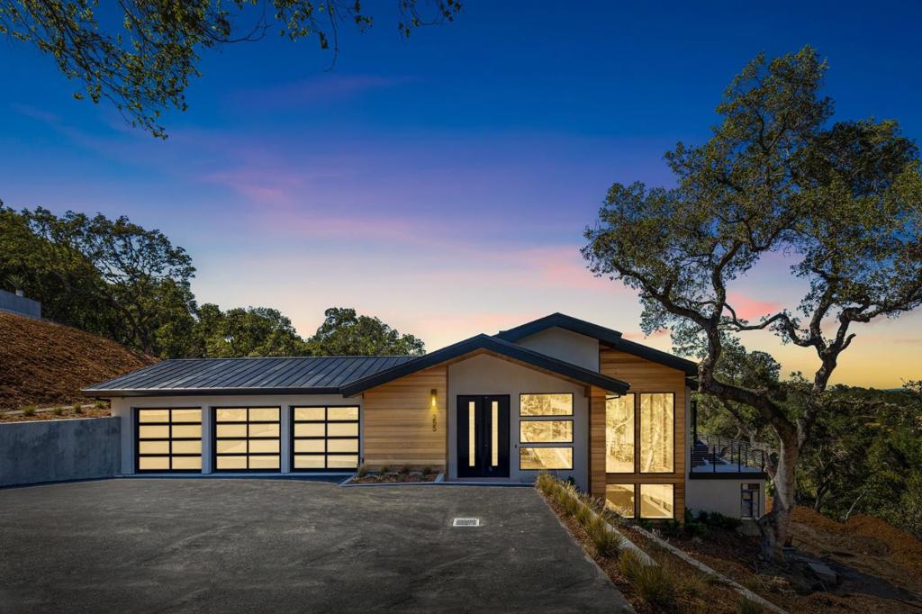 Stunning new construction home featuring sweeping Bay views, located on large private lot. The modern design of this one of a kind home offers a spacious and open floor plan, with high-end finishes and jaw dropping views from every room. Impressive floor-to-ceiling sliding glass doors provide a seamless indoor outdoor living space, with a grand fireplace acting as the perfect centerpiece. The gorgeous chef's kitchen is ideal for entertaining, with a massive center island, custom cabinetry, and high-end appliances. The spacious main bedroom features a generous walk-in closet, a luxurious en suite bathroom, and access to the deck with Bay views. A courtyard off of the kitchen offers a lovely dining area and an outdoor kitchen with a built-in BBQ. The lower level of the home offers a wet bar, wine cellar, and a large theater room prewired and ready for movie nights. Ideally located in the highly desirable community of Woodside, with quick access to all the Bay Area has to offer.