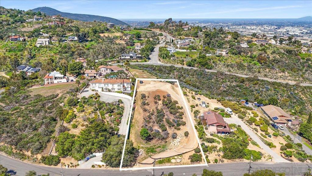 Hard to find view lot and nearly a full acre! Experience panoramic, unobstructed views (All the way to Big Bear on clear days) spanning 180 degrees from north to south on this prime, hilltop residential lot in the Coronado Hills of San Marcos. Very buildable...The building pad is approx. 100' wide by 50' deep and can be expanded, offering flexibility for your design. Features include a 1.5” water line, a 2,500-gallon water tank, and a 1,500-gallon professionally installed septic tank (leech field required) and utilities are nearby (Power/TV/Cable <5' ... H2O <15') for easy access. Bonus: Solar lights are strategically installed throughout the lot, and wildflowers have been planted, promising a beautiful bloom next spring. Close to everything, yet feels remote: Palomar & Kaiser Med Centers, Costco, restaurants, Stone Brewery Bistro & more. Easy access to the 78. Another bonus: No HOA. Oh, one more bonus: This qualifies for primary home, ADU and a Jr. ADU!!! Don’t miss out—Most of the prep work has been done!
