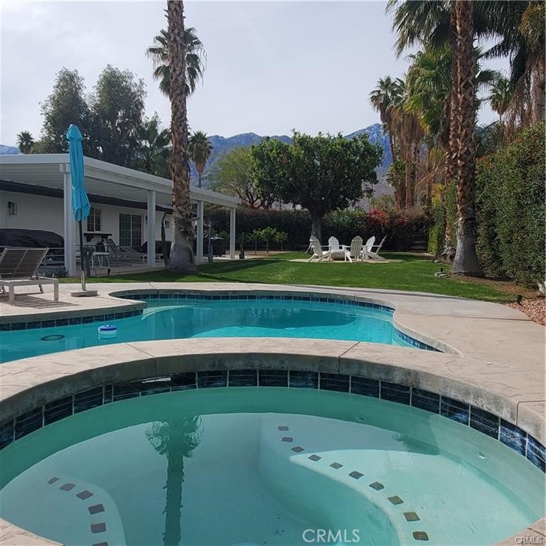 short term rental or Monthly! Welcome to Escoba Ranch, a fully remodeled and spacious three-bedroom home located just minutes from downtown Palm Springs and the Palm Springs International Airport with a massive private yard. Our large and private corner lot offers stunning views of the San Jacinto Mountains, accompanied by a salt water pool and jacuzzi, a 45-foot covered patio, a citrus orchard, a fire pit lounge, an outdoor shower, dual garage (with AV charger) all surrounded by a variety of palm trees, cacti, and desert flowers. Interior Highlights: This home is fully furnished! The open floor plan living and dining area features a 75-inch TV, a cozy fireplace, and an extra-large dining room that opens to the outdoor living area. The well-appointed kitchen is equipped with all the amenities needed to entertain and enjoy your stay in Palm Springs. Location Situated in the Los Compadres neighborhood of southeast Palm Springs—well south of the wind zone—Rancho Vista Del Sol provides quick access to the city's vibrant heart, including its restaurants, museums, shops, and galleries. We are conveniently located on the new Palm Springs CV Link (Coachella Valley bike path) and are just minutes away from the Prescott Nature Preserve, dog parks, and the Araby trail system, which leads to the famous Bob Hope House and beyond. Primary Suite: The luxurious primary bedroom serves as a private oasis, featuring a plush king-size bed with a beautiful wood headboard. A large sliding glass door allows natural light to illuminate the rich terrazzo floors and sleek mid-century modern furnishings. Additionally, there is a large-screen smart TV that can be neatly tucked away when not in use. A spacious closet provides ample storage, while the en-suite bathroom boasts a dual vanity with quartz countertops and an oversized walk-in shower complete with a rainfall showerhead and designer tile work. Second Bedroom: It features a queen-size bed, restored mid-century nightstands, and a large 65-inch TV. A large window frames picturesque mountain views, ensuring guests wake up to stunning desert landscapes. A well-appointed closet and stylish accent lighting round out this comfortable space. Third Bedroom: . Decorated with subtle mid-century modern touches and European wallpaper, this space combines practicality and style through soft textiles, fun wall treatments, and ample storage. Months of Januray thought April will be higher, Please contact me for details.