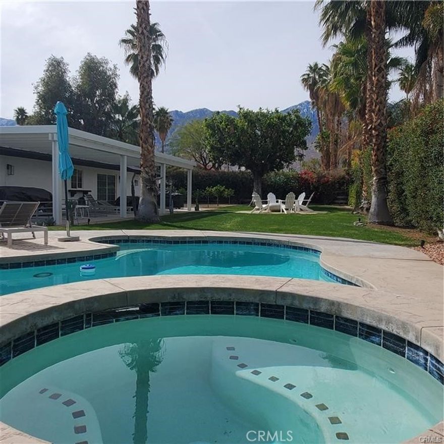 short term rental or Monthly!   Welcome to Escoba Ranch, a fully remodeled and spacious three-bedroom home located just minutes from downtown Palm Springs and the Palm Springs International Airport with a massive private yard. Our large and private corner lot offers stunning views of the San Jacinto Mountains, accompanied by a salt water pool and jacuzzi, a 45-foot covered patio, a citrus orchard, a fire pit lounge, an outdoor shower, dual garage (with AV charger) all surrounded by a variety of palm trees, cacti, and desert flowers. Interior Highlights: This home is fully furnished! The open floor plan living and dining area features a 75-inch TV, a cozy fireplace, and an extra-large dining room that opens to the outdoor living area. The well-appointed kitchen is equipped with all the amenities needed to entertain and enjoy your stay in Palm Springs. Location Situated in the Los Compadres neighborhood of southeast Palm Springs—well south of the wind zone—Rancho Vista Del Sol provides quick access to the city's vibrant heart, including its restaurants, museums, shops, and galleries. We are conveniently located on the new Palm Springs CV Link (Coachella Valley bike path) and are just minutes away from the Prescott Nature Preserve, dog parks, and the Araby trail system, which leads to the famous Bob Hope House and beyond. Primary Suite: The luxurious primary bedroom serves as a private oasis, featuring a plush king-size bed with a beautiful wood headboard. A large sliding glass door allows natural light to illuminate the rich terrazzo floors and sleek mid-century modern furnishings. Additionally, there is a large-screen smart TV that can be neatly tucked away when not in use. A spacious closet provides ample storage, while the en-suite bathroom boasts a dual vanity with quartz countertops and an oversized walk-in shower complete with a rainfall showerhead and designer tile work. Second Bedroom: It features a queen-size bed, restored mid-century nightstands, and a large 65-inch TV. A large window frames picturesque mountain views, ensuring guests wake up to stunning desert landscapes. A well-appointed closet and stylish accent lighting round out this comfortable space. Third Bedroom: . Decorated with subtle mid-century modern touches and European wallpaper, this space combines practicality and style through soft textiles, fun wall treatments, and ample storage. Months of Januray thought April will be higher,  Please contact me for details.