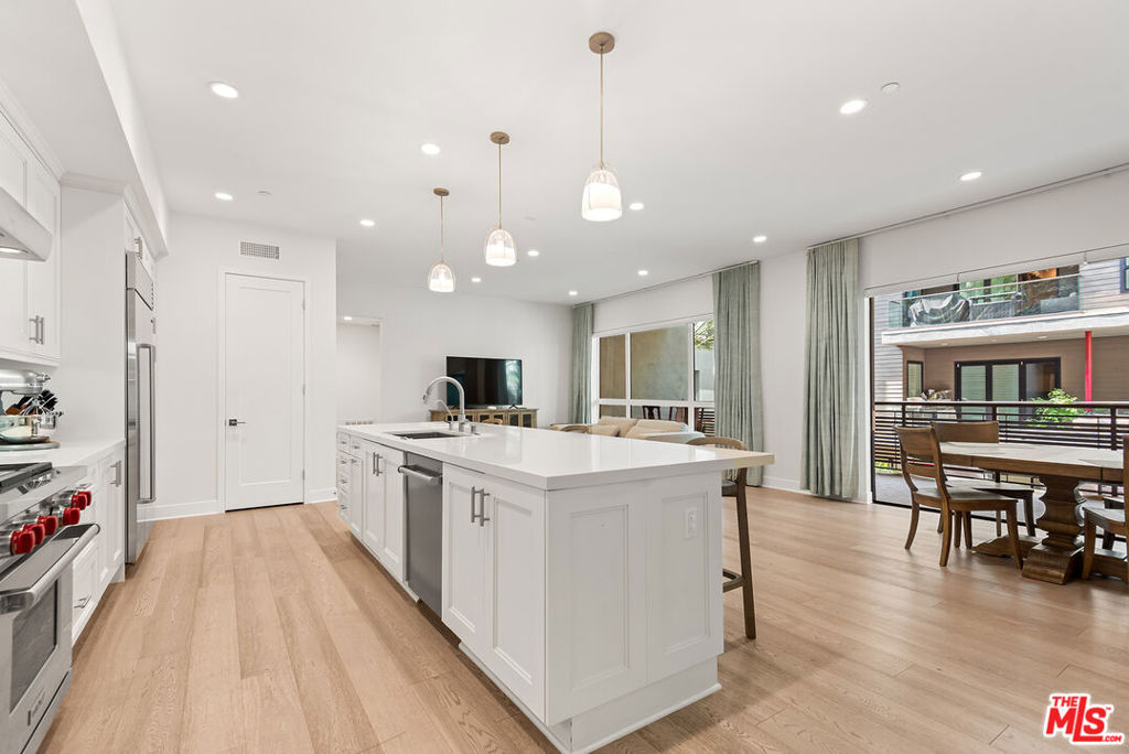 Step inside this stunning split-level townhome-style condo in the highly sought-after Cleo community of Playa Vista. With 4 spacious bedrooms, 3.5 bathrooms, and over 2,500 sq ft of beautifully designed living space, this rare south-facing residence combines modern luxury, comfort, and convenience. The main level showcases an expansive living room, open-concept kitchen, and a dedicated office nook. Off the living room, a large, covered balcony extends your living space outdoors, perfect for relaxing or entertaining. The chef's kitchen is light and bright and outfitted w/premium Wolf and Sub-Zero appliances and plenty of storage. The oversized primary suite offers a generous walk-in closet and a spa-inspired bathroom with dual vanities, a soaking tub, and a separate glass-enclosed shower. Two additional bedrooms and a full laundry room complete this level. The lower level offers a versatile flex room ideal as a 4th bedroom, media lounge, or home gym with its own private bathroom and closet, plus direct access to your private 2-car garage. Perfectly situated just steps from Runway's vibrant shops and restaurants as well as The Resort (gym/pool).