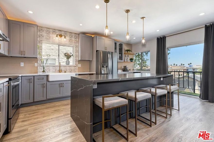 This beautifully renovated condominium with incredible views underwent a comprehensive, high-end remodel completed in August 2023. Every element was thoughtfully selected to enhance comfort, functionality, and modern appeal throughout the home. In an amenity-filled building, features a rarity for the complex... in-unit laundry! Enjoy the tasteful details of the Living Room, Eat-in-Kitchen with wine/coffee bar and enjoy the views of the beautiful city and Hollywood Sign from your expansive kitchen island or the patio. Both bathrooms, the hall bath and the Primary, have been remodeled, including the brand new soaking tub with glass door and waterfall shower head. Primary suite also includes an impressive walk-in-closet. Sought after building includes a list of impressive amenities, including year-round heated pool and spa, fitness room with sauna, recreation room and external storage for unit and provides Earthquake Insurance. Across the street from Beverly Hills and a block from Beverly Drive provides an easy access to restaurants, cafes, grocery stores and commuter routes. Don't miss out!