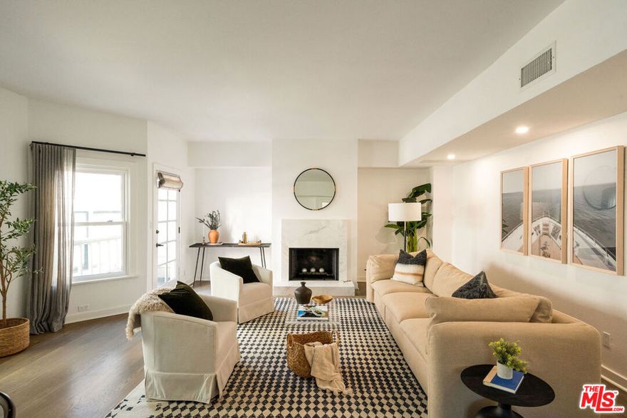 Coastal charm meets modern comfort in Ocean Park - this beautifully updated Victorian-style townhouse is just blocks from the Pacific Ocean! Spread across three spacious levels, the home features 3 bedrooms, 3 baths, and wonderful indoor/outdoor living, including a sun-filled rooftop deck with serene westward views toward the ocean. On the lower level, two bright and airy bedrooms with bay windows, walk-in closets, guest bathroom and enclosed laundry area create a private retreat. The primary suite opens to a secluded (and dog-friendly) private patio and boasts a beautifully renovated ensuite bath with heated floors, fireplace, motion-sensor lighting, high-end fixtures and LED mirror. The middle level is the heart of the home, where a chef's kitchen with a central island flows seamlessly into the open living and dining space. Natural light streams in through large windows, while a cozy fireplace and a private patio invite ocean breezes and effortless entertaining. Upstairs, a versatile third bedroom with fireplace, full bath, and French doors opens to a sun-drenched deck which faces west - ideal for a home office, gym, or simply a peaceful escape to capture sunsets and ocean breezes. Smart-home features include Alexa-controlled fireplace in primary bedroom, remote-activated locks, Ring security, and a digital thermostat. Additional amenities include two side-by-side underground parking spaces, security gates, extra storage, and an encased outdoor TV setup for year-round enjoyment. Part of an intimate three-unit community, this residence lives like a private home with minimal shared upkeep and one of the lowest HOA dues in the area. Just blocks from the Pacific, Abbot Kinney Blvd., Rose Ave., surrounded by Santa Monica's best cafes, restaurants, parks, and beaches, and within the highly desirable Santa Monica school district, this is a rare coastal gem that combines modern luxury, convenience, and a true sense of home.