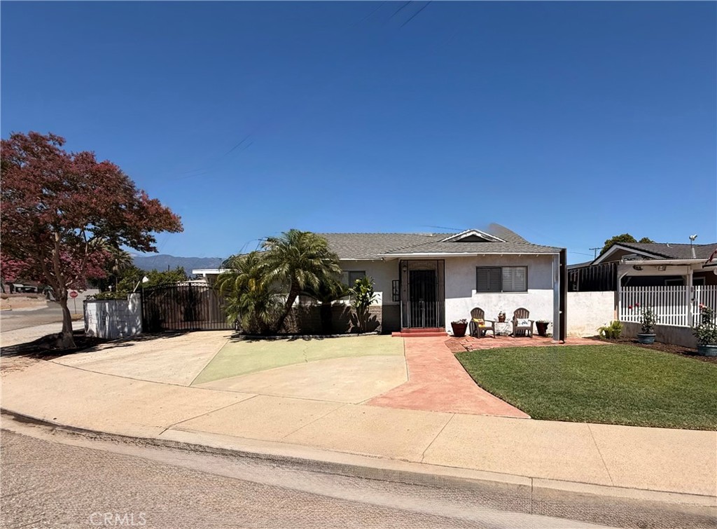 First Time on the Market!
This charming 3-bedroom, 2-bathroom single-story residence offers approximately 1510 sq ft of living space on a 5,297 sq ft lot. Built in 1962 by the current owner’s grandparents, this well-maintained home is being sold for the very first time. Features include an open floor plan, numerous windows throughout home with plantation shutters, wood laminate flooring throughout home, carpeted front room, ceiling fans in rooms, a beautifully remodeled kitchen and bathroom with tile flooring, large closets with sliding doors in two bedrooms, and a large, walk-in closet in the third. Sliding glass doors off the kitchen and rear bedroom offer easy backyard access. The property also offers a covered and partially enclosed parking structure with running water and electricity—perfect for parking, a workshop or additional storage. There is RV parking along the side of the home behind an enclosed gate, with additional space in the backyard for more. Located in a well-kept neighborhood directly behind Damien High School and just minutes from Frank G. Bonelli Regional Park—an 1,800-acre park featuring a 250-acre lake, multi-use trails, fishing, boating, jet skiing, designated swim beach, paddle board, and kayak rentals, biking, hiking, bird watching, picnic areas, playgrounds for kids. There is also an RV park with tent camping areas, pools, bathrooms with showers inside, laundry facilities, a small grocery store and more. Close to shopping, churches, schools, horse stables, major freeways, and Brackett Field Airport—home to Norm’s Café, a local favorite for plane-watching while you enjoy one of their scrumptious breakfast or lunch they are known for. Don’t miss this rare opportunity to own a home filled with family history, pride of ownership, and with a little TLC incredible potential!