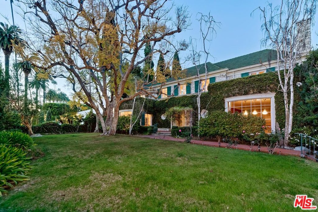 First broker previews by appointment only between 11-2 on Tuesday, April 13th. Please RSVP only via email to book a time. Trust Sale. 1st time available in 46 years. Sited on a lushly foliated corner lot of nearly 29,000 sq ft and over 300 feet deep, here is a once-in-a-generation opportunity to acquire and restore this glorious, grand, and classic 2sty Traditional estate by world-renowned Paul R. Williams, FAIA. The expected attention to detail is apparent throughout with extraordinary mouldings, wood floors, curvature, and French doors. Voluminous scale exhibited by a baronial-sized dining room, massive reception foyer with sweeping staircase, huge kitchen/great room, and a tremendous family room with bar. Kitchen/vaulted-ceiling great room and family room, and a striking oval breakfast room open to fabulous deep grounds with lawns, pond, pool, two separate guest units, office, pool baths. 4 magnificent bedroom suites upstairs along with a lounge area and laundry closet. Maid's quarters downstairs. Secondary laundry room near the guest units. Large basement area for extensive storage capabilities. A supreme address centrally located in the Flats of Beverly Hills along with a significant architectural pedigree makes this a property to cherish for many years to come.