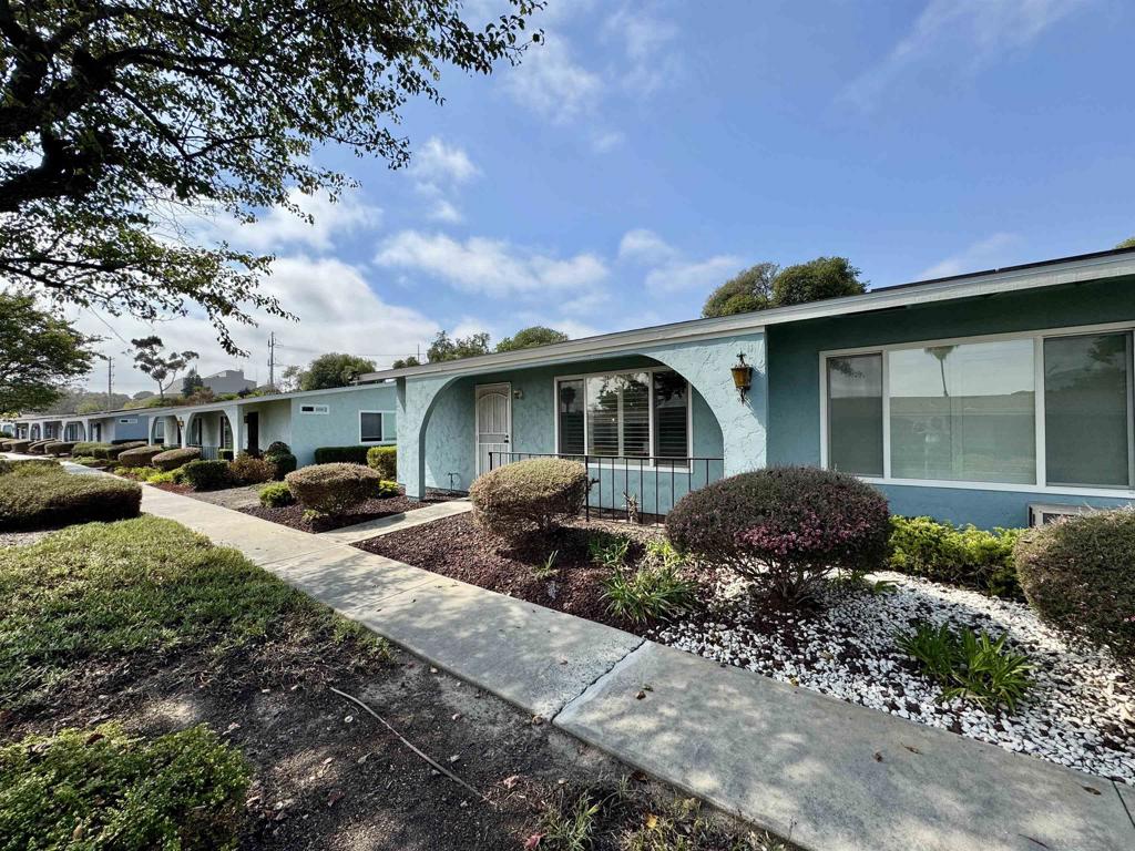 Location, location! This 55+ Oceana South 1 end unit home is nestled in a wonderful community and includes a one car garage and carport/patio. Upgraded throughout including new kitchen with granite counters, bathrooms, flooring, paint, air conditioning and windows! Nothing left to do but relax. Short walk to the clubhouse and pool/spa. HOA dues cover roof, water, trash, exterior landscaping and basic cable. Lots of activities each month to enjoy or chill at home and have friends over. The choice is yours!
