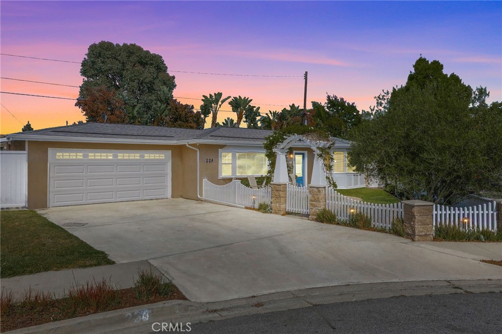 Welcome to this beautifully upgraded 2-bedroom, 2-bathroom single-level home, ideally situated on one of the few cul-de-sacs in Eastside Costa Mesa. Fully remodeled and thoughtfully designed, this home blends modern comfort with timeless craftsmanship. Step inside to find open-concept living, kitchen, and dining rooms that create a light-filled, inviting space... perfect for both everyday living and entertaining. The kitchen is a chef’s dream, featuring a professional-grade Wolf range and oven, a top-of-the-line KitchenAid refrigerator, and ample counter space. Stunning custom woodworking throughout, from built-in cabinetry to detailed wood paneling, adds warmth and character to every room. The expansive primary suite offers vaulted ceilings with exposed beams, custom closets, and a spa-like bathroom complete with a glass-block shower, rain shower-head, full-sized Jacuzzi tub, marble countertops, and limestone tile. The second bedroom includes a charming bay window and custom shelving, making it ideal for guests or a home office. Modern upgrades include central air conditioning, a tankless water heater for instant hot water, and a convenient covered side area that’s perfect for a workshop, extra storage, or even additional parking. Surrounded by lush gardens and framed by a classic white picket fence, this private and peaceful property offers a rare opportunity to own a truly special home in one of Costa Mesa’s most desirable neighborhoods.