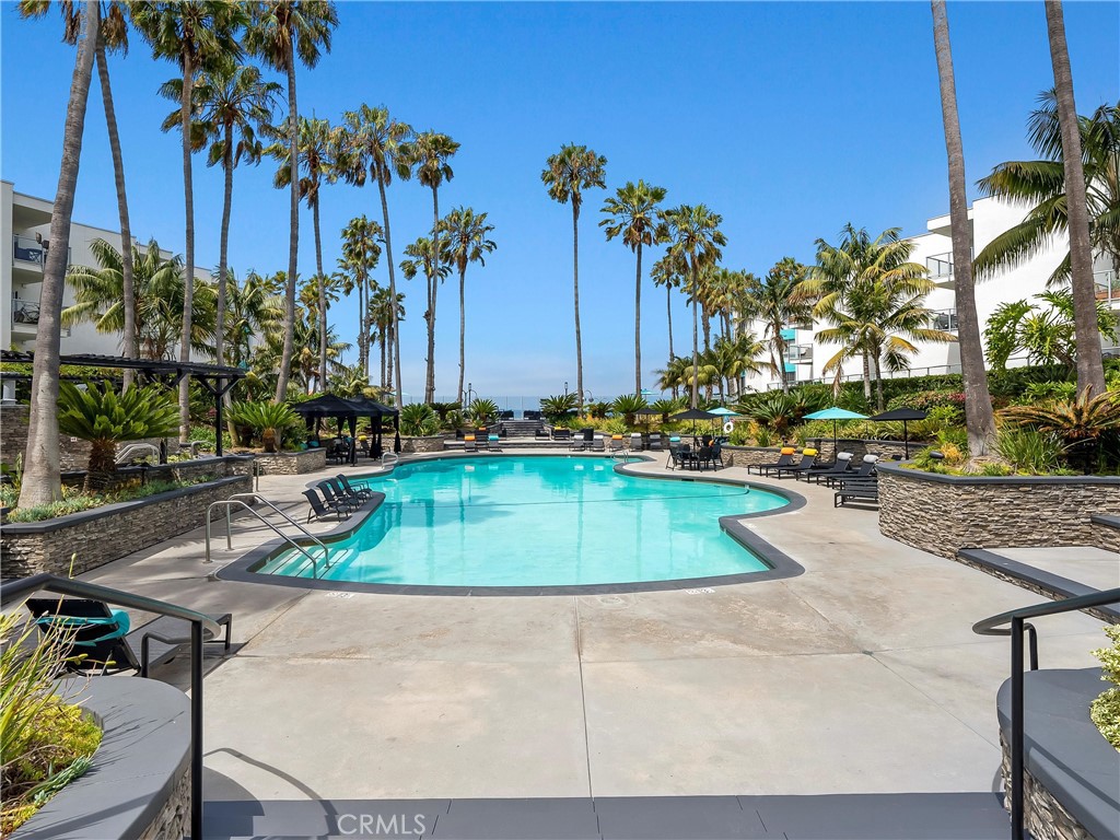 Hello Ocean View! Tucked along a lush, jungle-like pathway filled with greenery and sunshine, this rare ground-level unit feels like a private coastal retreat at the ocean. Follow the plant-lined walkway, and you’re immediately transported into a peaceful escape, no long indoor hallways or elevators here. Just a warm welcome straight to your own patio and entrance.
Step inside and feel the natural light pour into a space that’s been thoughtfully remodeled from top to bottom. Enjoy your ocean view from your kitchen, dining and patio. The open-concept remodeled kitchen flows seamlessly into the patio and living area. Lounge on the couch, cuddled up next to the electric fireplace while your morning coffee brews, taking in the waves crashing just down the hill. It's bright, happy, and full of the laid-back energy that makes Redondo Beach so special. This community offers luxury swimming pools, hot tubs, BBQ areas, and gyms.
One of the rarest features here? An in-unit washer and dryer, a true luxury in The Village. Two-car reserved tandem parking adds to the comfort, convenience, and charm of this beautiful home. This home sits just above the famous Redondo Beach Pier & Pacific Ocean, restaurants, and the 22 mile Marvin Braude Bike Path along The Strand.