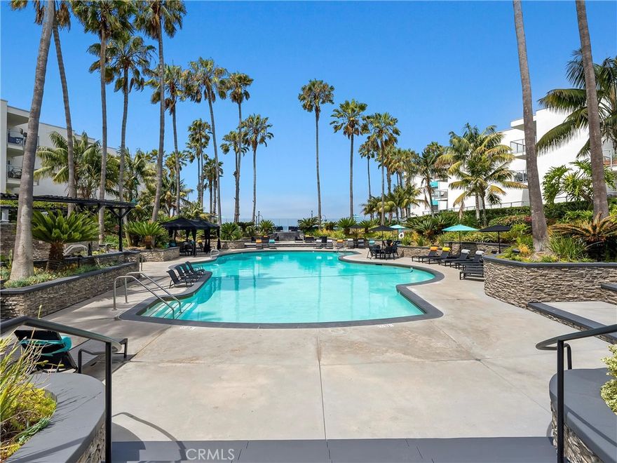 Hello Ocean View! Tucked along a lush, jungle-like pathway filled with greenery and sunshine, this rare ground-level unit feels like a private coastal retreat at the ocean. Follow the plant-lined walkway, and you’re immediately transported into a peaceful escape, no long indoor hallways or elevators here. Just a warm welcome straight to your own patio and entrance.

Step inside and feel the natural light pour into a space that’s been thoughtfully remodeled from top to bottom. Enjoy your ocean view from your kitchen, dining and patio. The open-concept remodeled kitchen flows seamlessly into the patio and living area. Lounge on the couch, cuddled up next to the electric fireplace while your morning coffee brews, taking in the waves crashing just down the hill. It's bright, happy, and full of the laid-back energy that makes Redondo Beach so special. This community offers luxury swimming pools, hot tubs, BBQ areas, and gyms. 

One of the rarest features here? An in-unit washer and dryer, a true luxury in The Village. Two-car reserved tandem parking adds to the comfort, convenience, and charm of this beautiful home. This home sits just above the famous Redondo Beach Pier & Pacific Ocean, restaurants, and the 22 mile Marvin Braude Bike Path along The Strand.