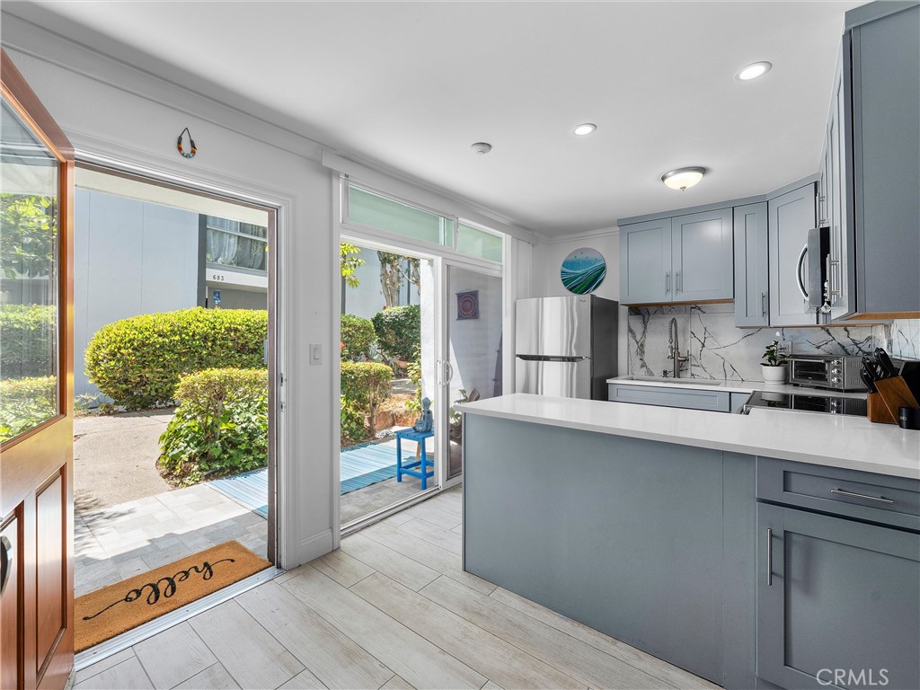 Hello Ocean View! Tucked along a lush, jungle-like pathway filled with greenery and sunshine, this rare ground-level unit feels like a private coastal retreat at the ocean. Follow the plant-lined walkway, and you’re immediately transported into a peaceful escape, no long indoor hallways or elevators here. Just a warm welcome straight to your own patio and entrance.
Step inside and feel the natural light pour into a space that’s been thoughtfully remodeled from top to bottom. Enjoy your ocean view from your kitchen, dining and patio. The open-concept remodeled kitchen flows seamlessly into the patio and living area. Lounge on the couch, cuddled up next to the electric fireplace while your morning coffee brews, taking in the waves crashing just down the hill. It's bright, happy, and full of the laid-back energy that makes Redondo Beach so special. This community offers luxury swimming pools, hot tubs, BBQ areas, and gyms.
One of the rarest features here? An in-unit washer and dryer, a true luxury in The Village. Two-car reserved tandem parking adds to the comfort, convenience, and charm of this beautiful home. This home sits just above the famous Redondo Beach Pier & Pacific Ocean, restaurants, and the 22 mile Marvin Braude Bike Path along The Strand.