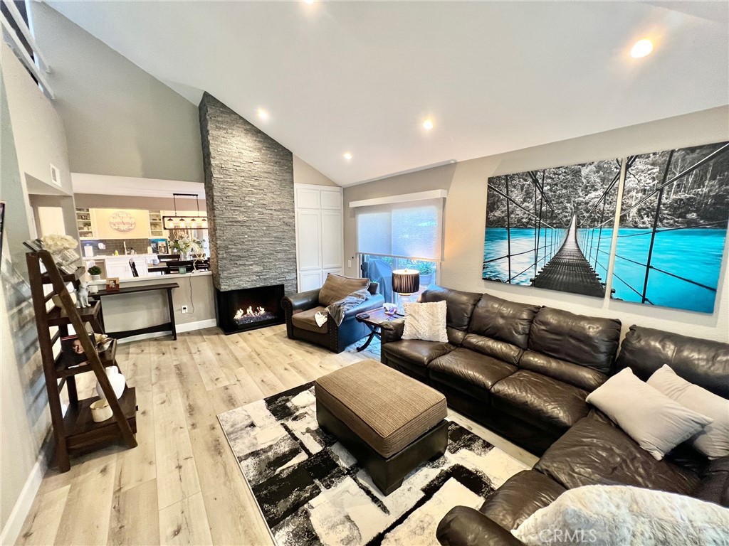 Welcome to your serene retreat at the Las Fuentes gated community in Huntington Harbour. This beautifully upgraded 2-bedroom + loft, 2.5-bathroom townhome offers a spacious and open floor plan, perfect for entertaining. Every detail has been thoughtfully remodeled to create a stylish modern living space. The designer kitchen boasts ample storage and counter space, allowing the chef to interact with guests in the dining and living areas. The kitchen, dining and living room each offer direct access to the adjacent patio filling the space with natural light and create a bright, inviting atmosphere- perfect for indoor-outdoor entertaining. Newly installed electric shades on all three sliding doors provide both privacy and convenience. The bar area with wine fridge is easily accessible from the dining area, making it perfect for hosting. The living room features soaring ceilings and striking gas-burning fireplace creating a cozy yet grand atmosphere. Conveniently, there is a guest bathroom downstairs and direct access to the attached two-car garage. Upstairs, you will find two generously sized suites, each with vaulted ceilings and walk-in closets. The primary suite offers a private balcony overlooking the lush central grounds, providing a peaceful spot to enjoy summer nights. The loft space is an excellent addition, perfect as an office or a potential third bedroom. For added convenience, the side-by-side laundry areas is located upstairs. The community offers lush landscaping with fountains, a pool, spa, sauna and clubhouse. Enjoy the Huntington Beach lifestyle just minutes from the Harbour, Sunset Beach, Bolsa Chica State Beach and the Bolsa Chica Wetlands.
