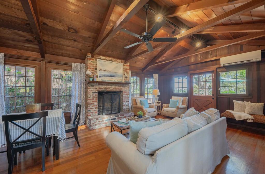 Looking for your next getaway? Inside this wonderfully unique property, you'll find board and baton wood walls, open beam ceilings, a brick fireplace, and windows overlooking the expansive yard and distant views of the Monterey Bay. Enjoy indoor/outdoor living with multiple patios/decks. Each of the two bedrooms has its own en-suite, making everyday living or vacation stays more convenient. With the new detached office/workshop space, working from home or having your own hobby room allows for flexibility. Move right in or explore the previously approved plans for a new two-story home with a garage. Located within the Pacific Grove Unified School District attendance area. See you soon!