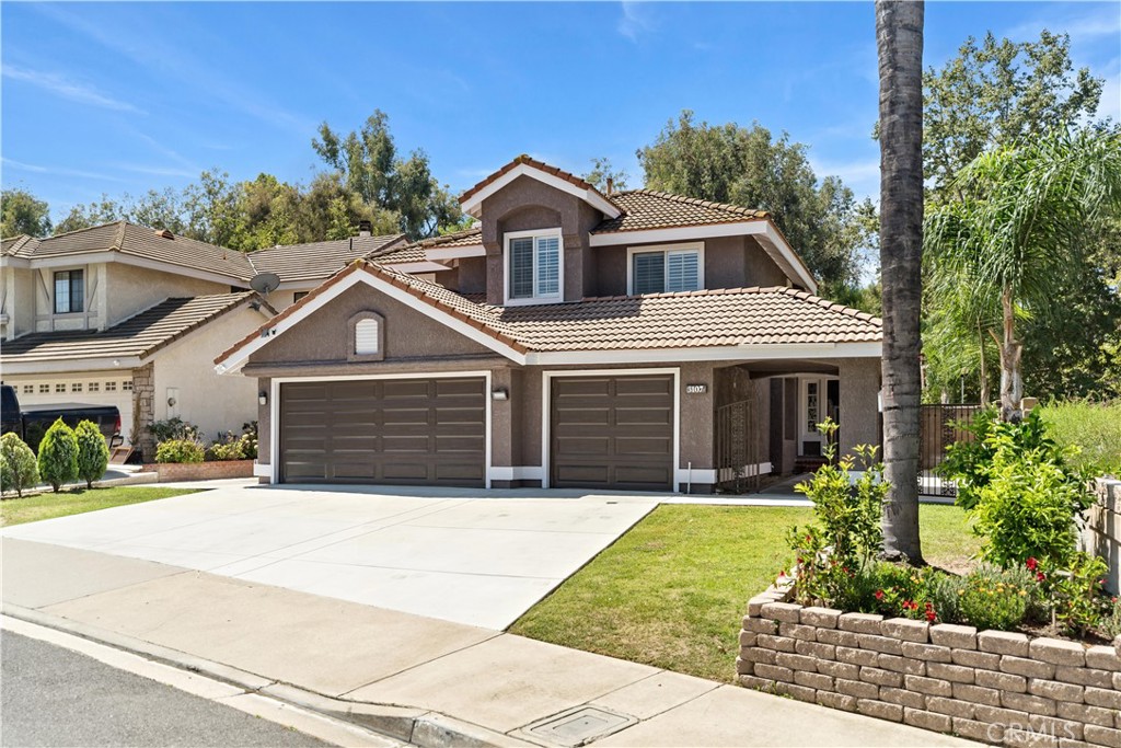 This beautifully maintained 4-bedroom, 3-bath home includes a convenient downstairs bedroom and full bath. Featuring vaulted ceilings, a sliding door opens to a serene backyard, and a spacious family room with a fireplace and wet bar—perfect for both relaxing and entertaining. The luxurious master suite includes a sitting area, fireplace, balcony, and an en-suite bath with a soaking tub and walk-in closet. Additional features include dual A/C units and a 3-car attached garage. Enjoy a private backyard with no neighbors to the west side or behind, mature landscaping, and a large covered patio. Located in a quiet neighborhood with top-rated schools nearby, this home is a true gem in Chino Hills!