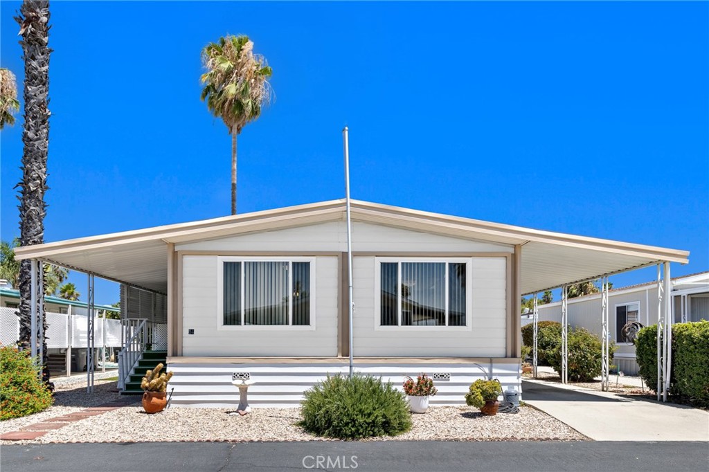 Lovely 2 bedroom 2 bath double-wide in Eden Roc North 55yr+ senior mobile home park. Spacious carpeted living/dining area with ceiling fan, stained glass fixture, and built-in china hutch. Vinyl wood-look flooring throughout the remainder of the home. Round-style kitchen with gas stove, dishwasher, refrigerator, and handy buffet bar open to family room with sliding glass door to covered porch. Master has large closet, ceiling fan, linen closet, garden tub and separate stall shower. Inside laundry, Dog run, Raised cover porch, 2 sheds. Loads of recreational options including, clubhouse, card room, pool, spa, and other options.