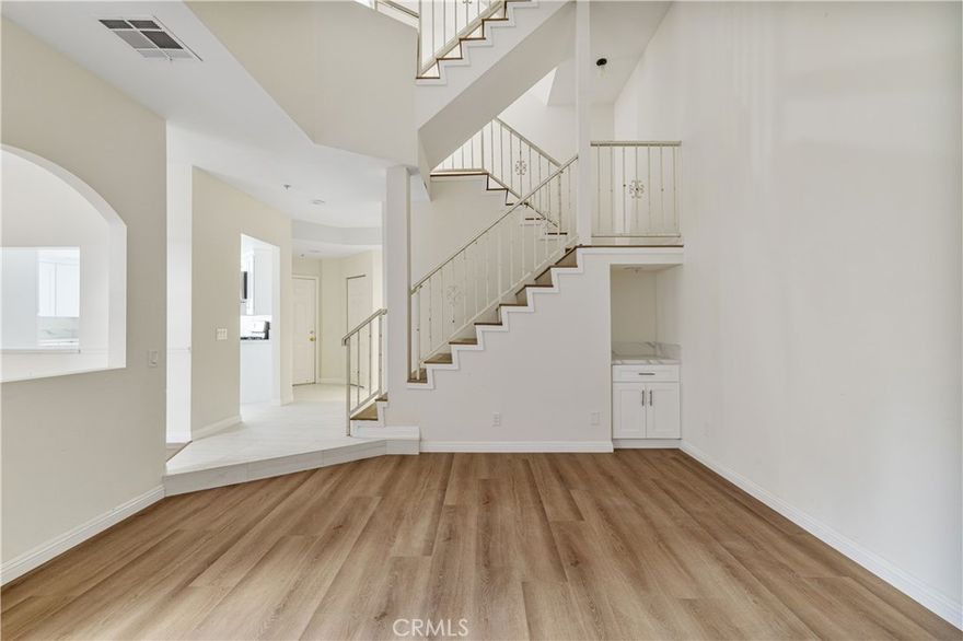 Located in the gated community of Astoria Gardens, this beautifully upgraded 3-bedroom, 2.5-bath home stands out for its stunning architectural design, vaulted ceilings, and warm, inviting style. The kitchen has been remodeled with stone countertops, stainless steel appliances, and modern finishes. Every surface throughout the home shows off gorgeous upgrades. The living room features a cozy fireplace and connects to a formal dining area thats perfect for entertaining. Upstairs, the spacious primary suite offers a walk-in closet, private balcony, and a fully remodeled bathroom, while the secondary bedrooms and bath have also been updated with the same attention to detail. On the third level, a private skydeck captures peaceful mountain views, an ideal place to unwind. Complete with an attached two-car garage, indoor laundry and HOA coverage for trash, water, and front yard maintenance. This move-in-ready home blends style, comfort, and function in one of Sylmar's most desirable gated communities.