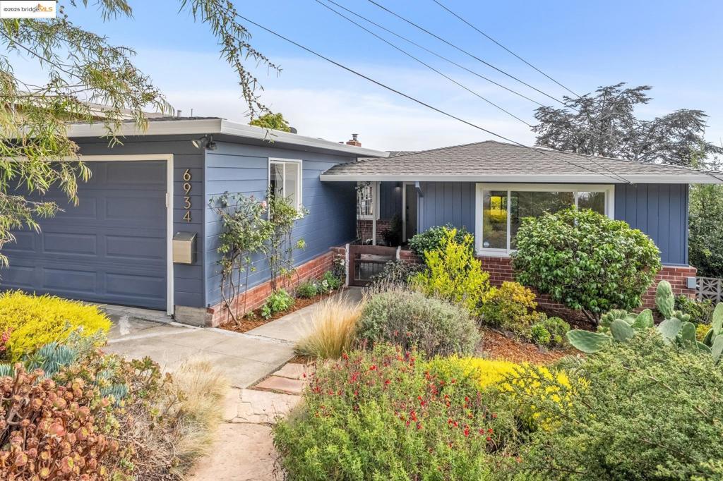 Graciously set back from the street and completely level-in with incredible views, 6934 Fairview offers easy living with space for everyone. The expansive view captures your attention the minute you walk in and is enjoyed from the living room, dining room, kitchen, deck, and primary bedroom. Enjoy your day while gazing at SF, the Golden Gate & Bay Bridges, Mount Tam, and the Bay. Out front, one is greeted by a professionally landscaped front garden with a private patio and breezeway. Through the front door is an ideally laid out space with expansive living room, dining room, and remodeled kitchen all centered around an elegant fireplace and directly connected to the view deck. Custom wood windows, stainless steel appliances, granite countertops, and designer light fixtures bring a feeling of finish and refinement. Rounding out the main floor are 3 spacious bedrooms and one large bathroom. Down from the main level is more space to spread out with the 4th bedroom, 2nd bathroom, and large family room that directly connects to the back garden. Elevated vegetable beds, well designed conversation spaces, and a plush lawn draw you outside to the beautifully cultivated back garden. Ideally located near Canyon Trail Park, Motorcycle Hill, and so much more! Zoned Madera Elementary.