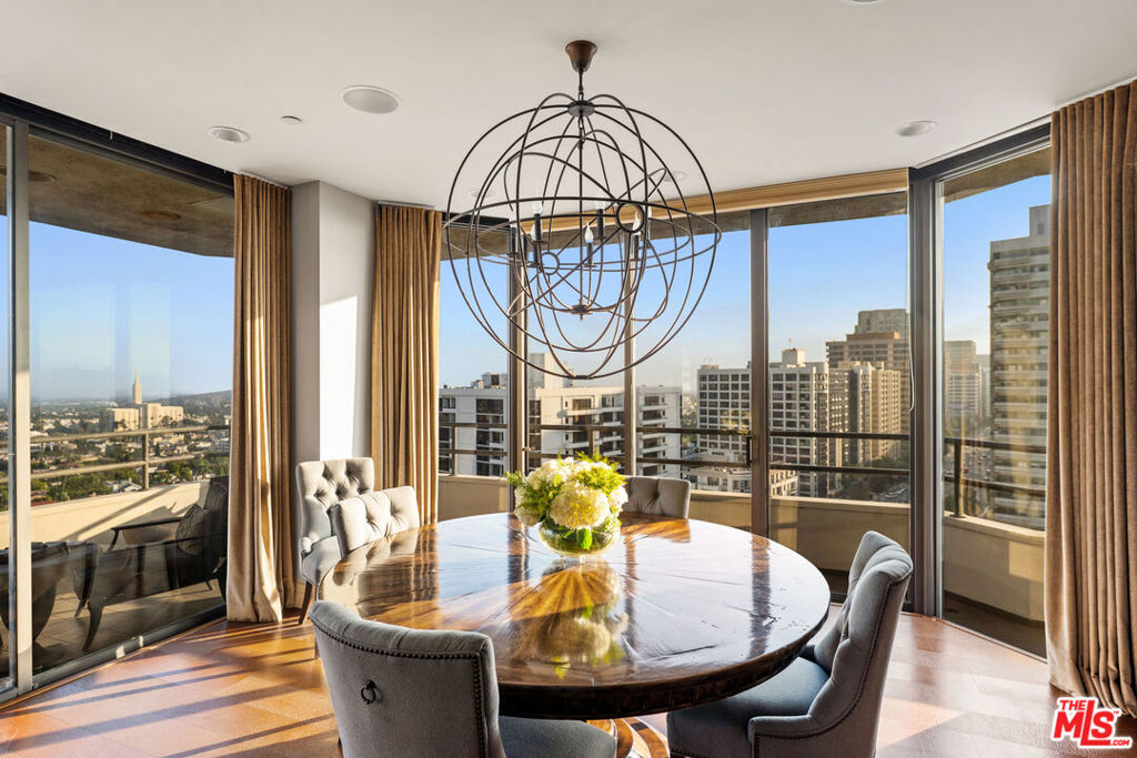 Welcome to one of the most coveted addresses on the Wilshire Corridor, Wilshire House, the only "A" building with wrap-around balconies. This completely remodeled southwest-facing residence showcases spectacular city vistas, ocean views, and Catalina Island on a clear day, all framed by floor-to-ceiling glass and a balcony that spans the length of the condo. Step into a grand marble entry that flows into a sophisticated living space with hardwood floors and abundant natural light, ideal for entertaining. The dining room opens to the stunning views and features a one-of-a-kind custom bar designed for unforgettable gatherings. The kitchen offers new appliances and elegant finishes. The luxurious primary suite boasts two walk-in closets and a marble bath. The second bedroom with its own bath works beautifully as a guest room, den, or home office. Special features include a built-in wine cellar and custom leather floors in the dining room and primary bedroom. Wilshire House Amenities: 24-hour valet & security, In-house engineers for on-demand repairs, lit tennis court, Saline swimming pool, & spa, fire pit & outdoor entertaining area, State-of-the-art fitness center, Recreation/banquet room, library, elegant lobby with a tranquil waterfall feature. No open houses permitted; private tours available by appointment.