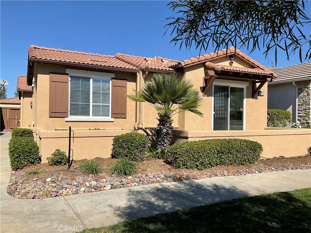 Welcome to 8251 Triplett Lane located in the active senior 55+ Four Seasons at Hemet Guard Gated Community with resort like amenities to make you feel like you are on vacation at home. 
This newly upgraded 2 Bedroom 2 Bathroom approx. 1,439 square foot home is located near community amenities including the Lodge. The home has a view of the lovely greenbelt & San Jacinto Mountains. The home is freshly painted on the exterior & interior. The courtyard patio invites you to enter the front door into the spacious living room which features new carpeting, ceramic tile, self-igniting gas fireplace, sliding glass door opens to the private patio. The heart of any home is the kitchen, and this one will not disappoint. The galley kitchen features an abundance of cabinet space with new white shaker cabinets w/brushed nickel handles & slow close drawers. Lovely coordinating Quartz countertops, ceramic tile flooring and a 36” wide granite top Island with drawers. Appliances include: Whirlpool 5 burner stove w/air fry/air baking, new super powerful range hood & newer Midea dishwasher. New kitchen sink has a brushed nickel Moen faucet and Moen garbage disposal. Refrigerator space w/new water hook-ups. A glass block window like feature above sink combines natural light with privacy. Just off kitchen a sliding glass door to a 2nd outdoor patio. The 2 Bedrooms are on each side of the living room. The primary off the living room has walk-in closet, new ceiling fan w/remote, en-suite bathroom with a shower- tub, dual vanity sinks, private toilet. Across the hall the laundry room with washer & gas dryer hooks ups, direct access 2 car-garage w/garage door opener. The second bedroom has closet, new ceiling fan w/remote. Nearby is the second full bathroom with single sink vanity, shower -tub & toilet. This home features Brand new Goodman Air conditioner & heating system. New Blinds, double pane windows, curtains for the sliding doors. 
Within the gates residents are greeted with a resort-style lineup of world-class amenities. 
The Lodge includes a ballroom, bistro, salon, barbecue area, arts & crafts, library, card room, computer room, movie theater, billiards room, fitness center & you don't want to miss Bingo night! The Lodge also offers a conference room, dining room w/kitchen for events or entertaining. Outdoor amenities: tennis, bocce ball & pickleball courts as well as a resort-style pool and spa. The picturesque Hemet Golf Club is woven throughout Four Seasons at Hemet.