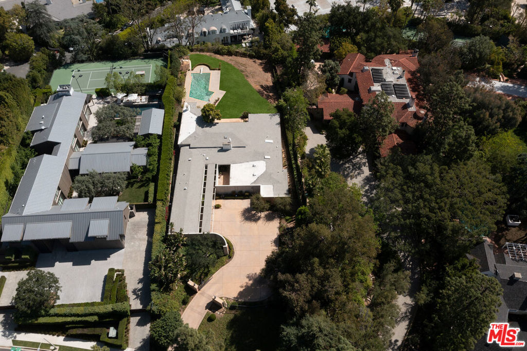 Once in a lifetime opportunity to own an unparalleled property on the prestigious 900 block of North Alpine Drive. Enter into a large motor court, and walk through the front doors and be faced with immediate stunning city views. This 34,010 square foot lot features city views and a dramatic backyard, complete with mature trees and lush landscaping. Built in 1954, the 5,458 square foot house boasts high ceilings and great bones. Complete rehab, tear down or development opportunity.