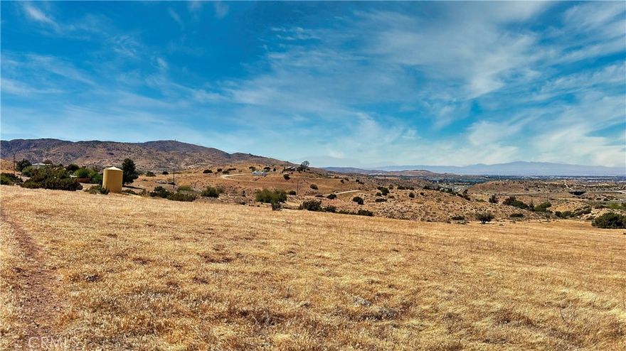 Massive 5-Acre Residential Land! Located in a quiet and private hilltop overlooking Palmdale, with good access to power, roads, and freeway. This property has potential for a lot split, which will allow a buyer to build two homes on it. Live in one and rent the other for positive income, or build your dream ranch and live in serenity, in your secluded sanctuary, while still being close to the city. Do you want to add more land? There is also a 5-acre parcel adjacent for sale! You can have a massive total of a 10-acre lot. You can start building now, or you can hold the land to sell later as more people flee city life in search of solitude. The buyer or selling agents are to verify lot lines and utility information. The seller states that the adjoining properties have good producing wells. Great Property at a good price.