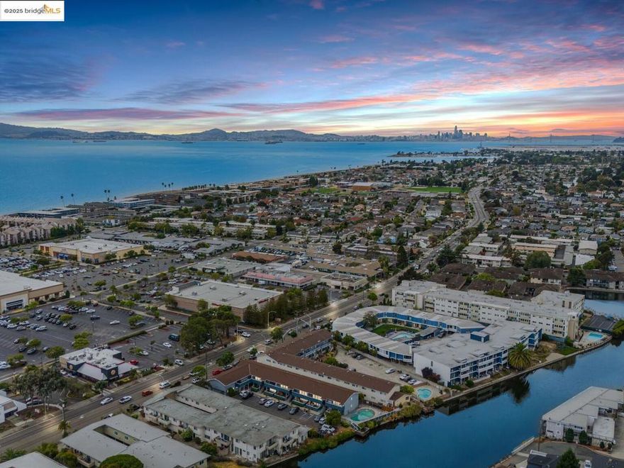 A stylishly updated upper-level condo in the heart of Alameda, with 809 sqft of light-filled living space designed for both comfort and convenience. The open floor plan features a sleek kitchen with quartz countertops, stainless steel appliances, a designer backsplash, and ample cabinetry, flowing seamlessly into the spacious living room and out to a private balcony, perfect for relaxing or entertaining. Both bedrooms are generously sized, while the updated bathroom showcases a chic vanity, elegant finishes, and a rainfall shower. Wood flooring, recessed lighting, and thoughtfully chosen details throughout create a warm yet modern atmosphere. The well-maintained community includes a sparkling pool and laundry facilities, adding ease to everyday living. Just steps from South Shore Center, you’ll enjoy direct access to shops, restaurants, groceries, and cafés, with Trader Joe’s, Safeway, and local dining at your doorstep. Outdoor enthusiasts will love being close to Alameda Beach, Crown Memorial shoreline, and scenic bay trails, while commuters appreciate the convenience of nearby public transit and freeway access. Ideal for first-time buyers, downsizers, or investors, this condo blends modern updates, low-maintenance living, and an unbeatable location in Alameda - a must see!
