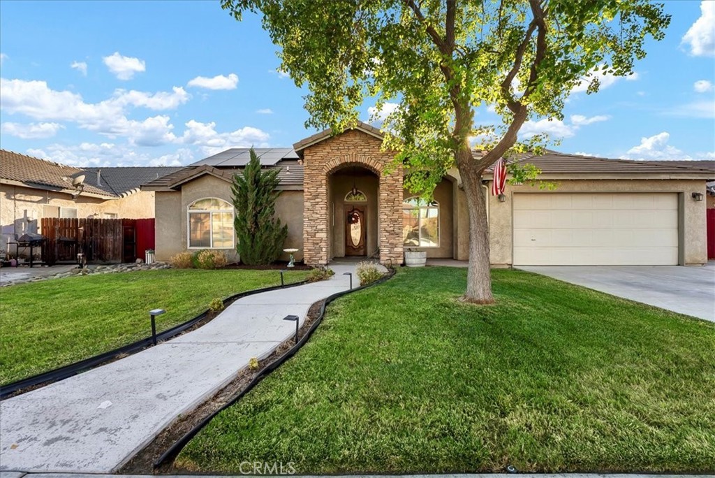 Style, space, and functionality come together in this beautifully updated 4-bedroom, 2-bathroom home in a desirable Lemoore cul-de-sac. With 2,193 sq ft of living space, this thoughtfully designed layout features a split floor plan and a huge bonus living room that feels like its own private wing- perfect for large families or multi-use living. Enjoy low energy bills with both owned and leased solar, ideal for keeping your electric consumption covered year-round. The home features wood laminate flooring, vaulted ceilings, and tons of natural light. Freshly painted throughout with gorgeously renovated tiled bathrooms, plus a stunning chef-style kitchen complete with granite counters, subway tile backsplash, a large center island, and new stainless steel appliances. The fourth bedroom includes French doors and is ideal as a home office or flex space. Step outside to a backyard designed for relaxing and entertaining: fresh sod, a large covered patio, vegetable garden, and paved side yard for your Recreational Vehicles or toys. Located just minutes from NAS Lemoore and Highway 41 access, and with plenty of parking thanks to the extended driveway and cul-de-sac setting- this home is a rare find. Schedule your private showing today! Bed count differs from tax records. Buyer to verify.